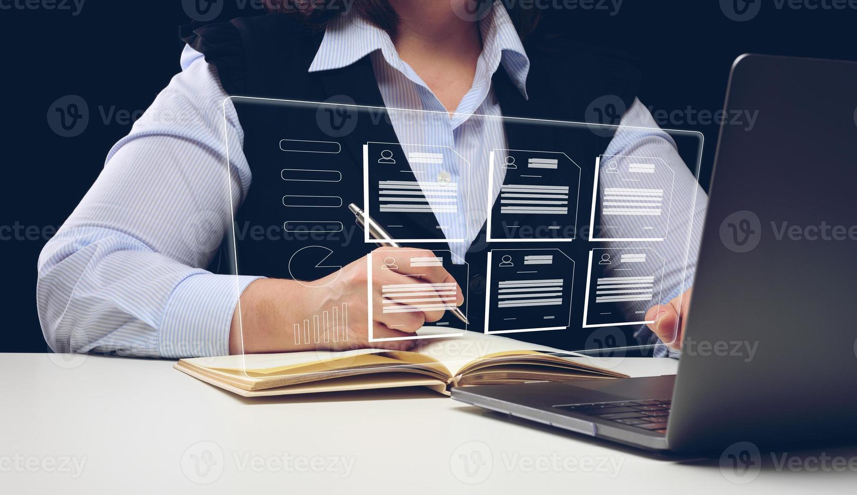 a woman sits at a table and works at a laptop, the recruitment process. Selection of talented employees, career development photo