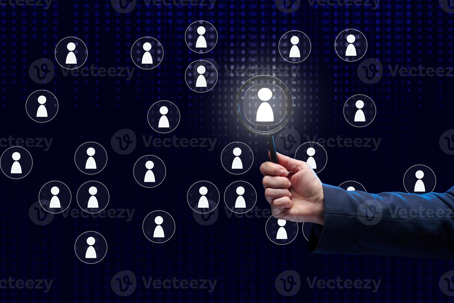 businessman holds in his hand a magnifying glass and an interactive scoreboard with company employees, selection of talented employees. Career growth photo