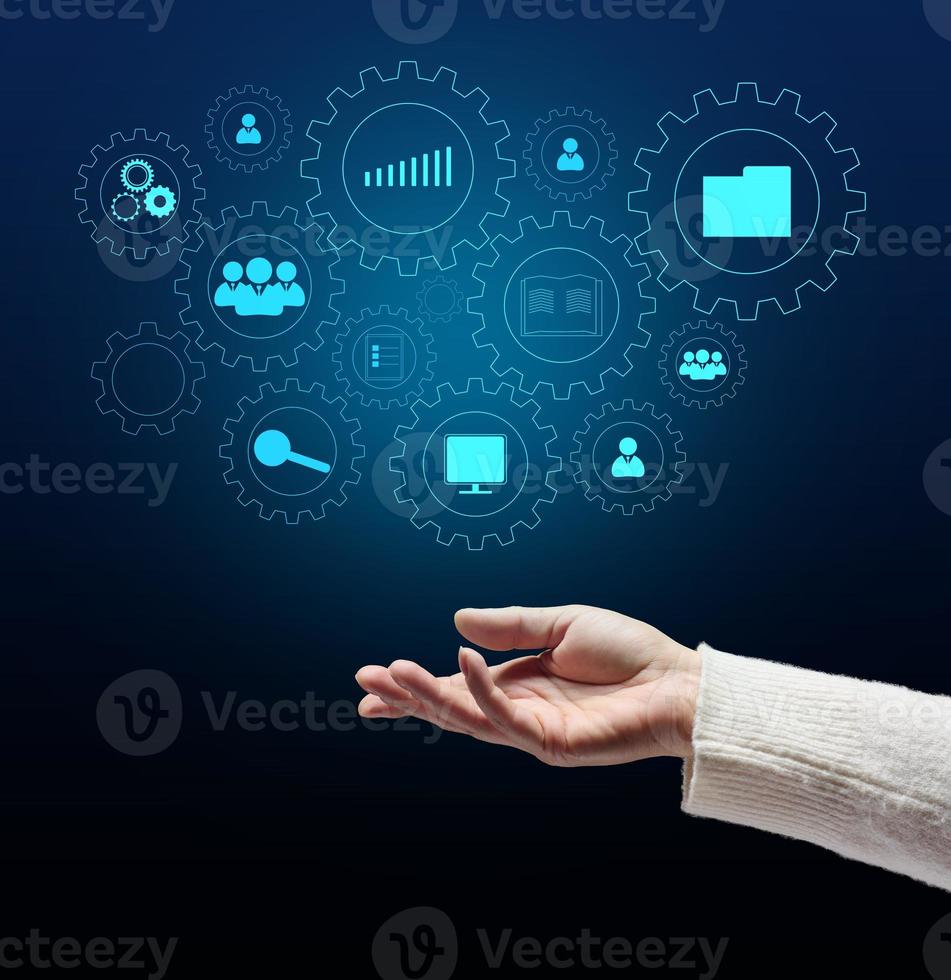 Control and management of business processes in the enterprise for efficient operation and increased profits. Concept with manager's hand and gears on holographic screen photo
