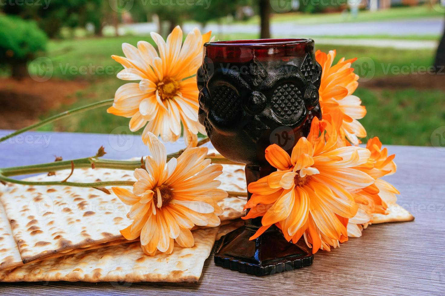 passover background. wine and matzoh over wooden table. process. photo