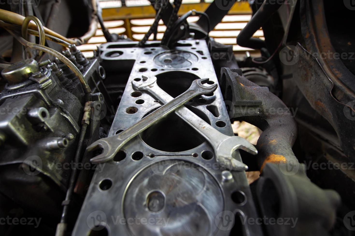 Mercedes diesel engine repair. Hands with a mechanic repairing Mercedes parts. Disassembled old engine. photo