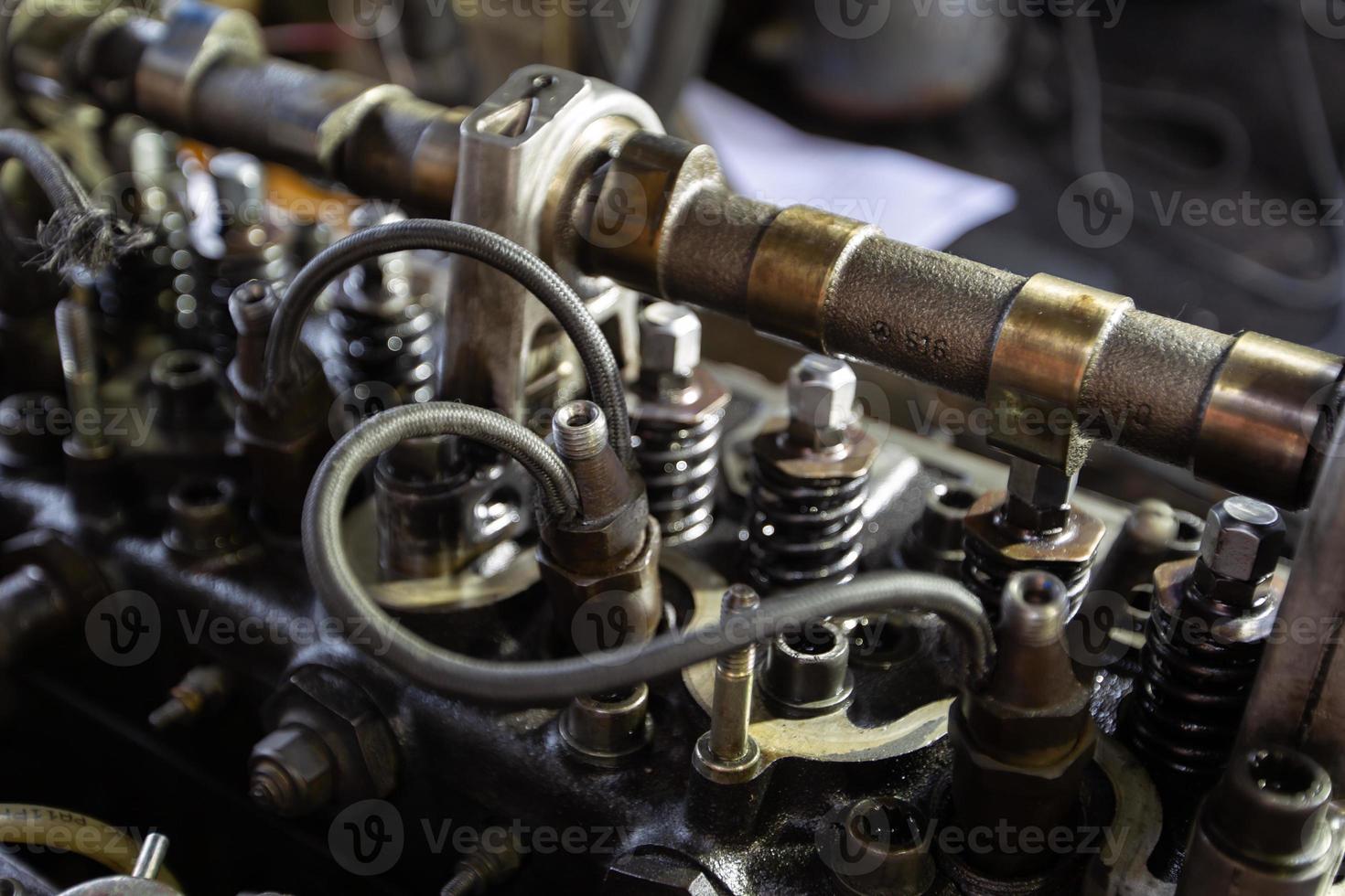 Mercedes diesel engine repair. Hands with a mechanic repairing Mercedes parts. The gas distribution mechanism of the fuel system of the car. photo