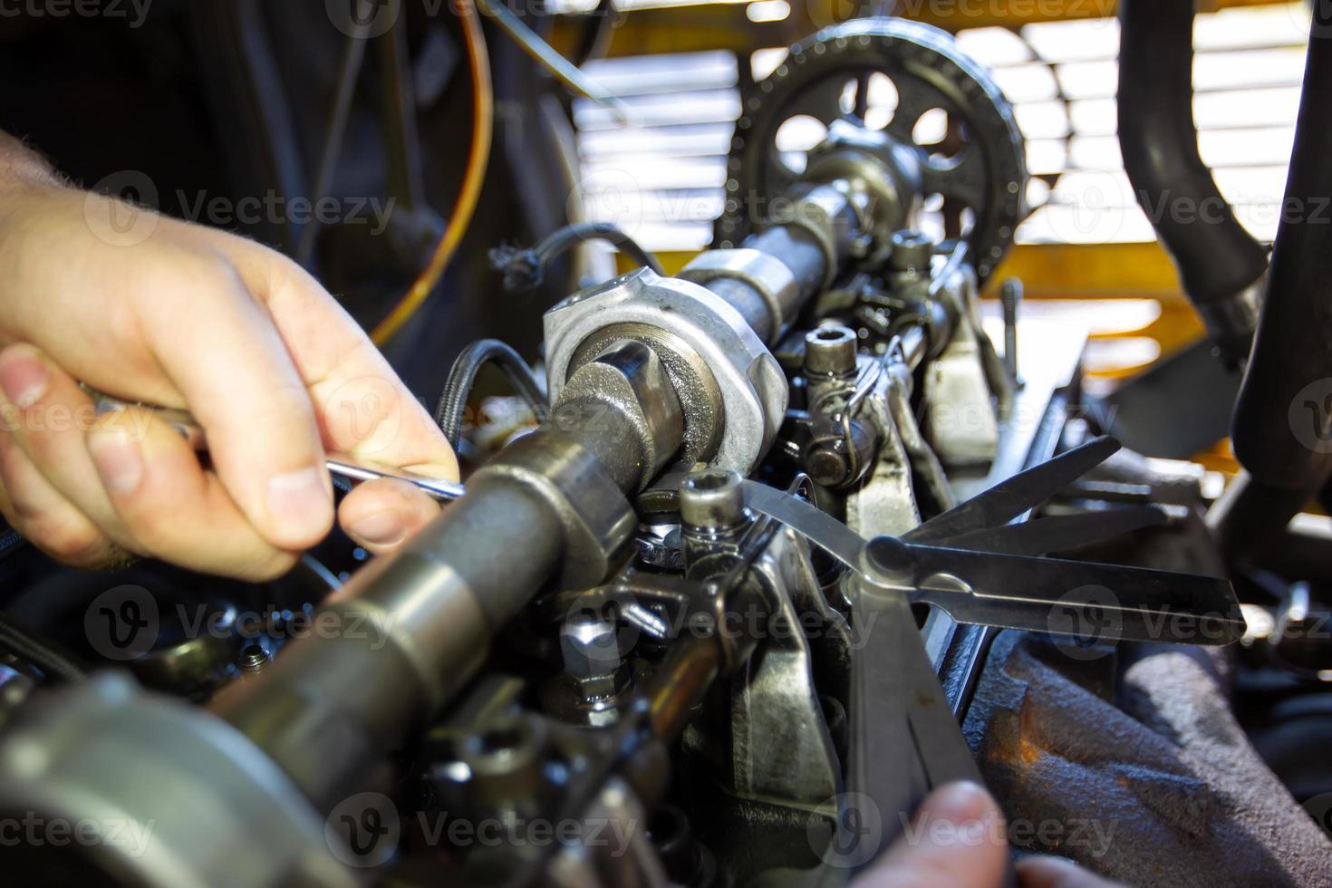 Mercedes diesel engine repair. Hands with a mechanic repairing Mercedes
