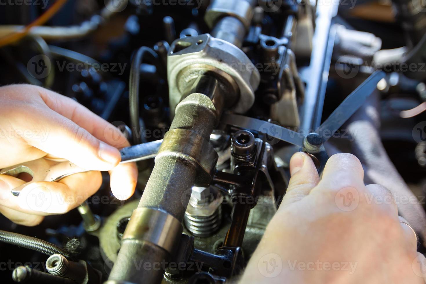 Mercedes diesel engine repair. Hands with a mechanic repairing Mercedes