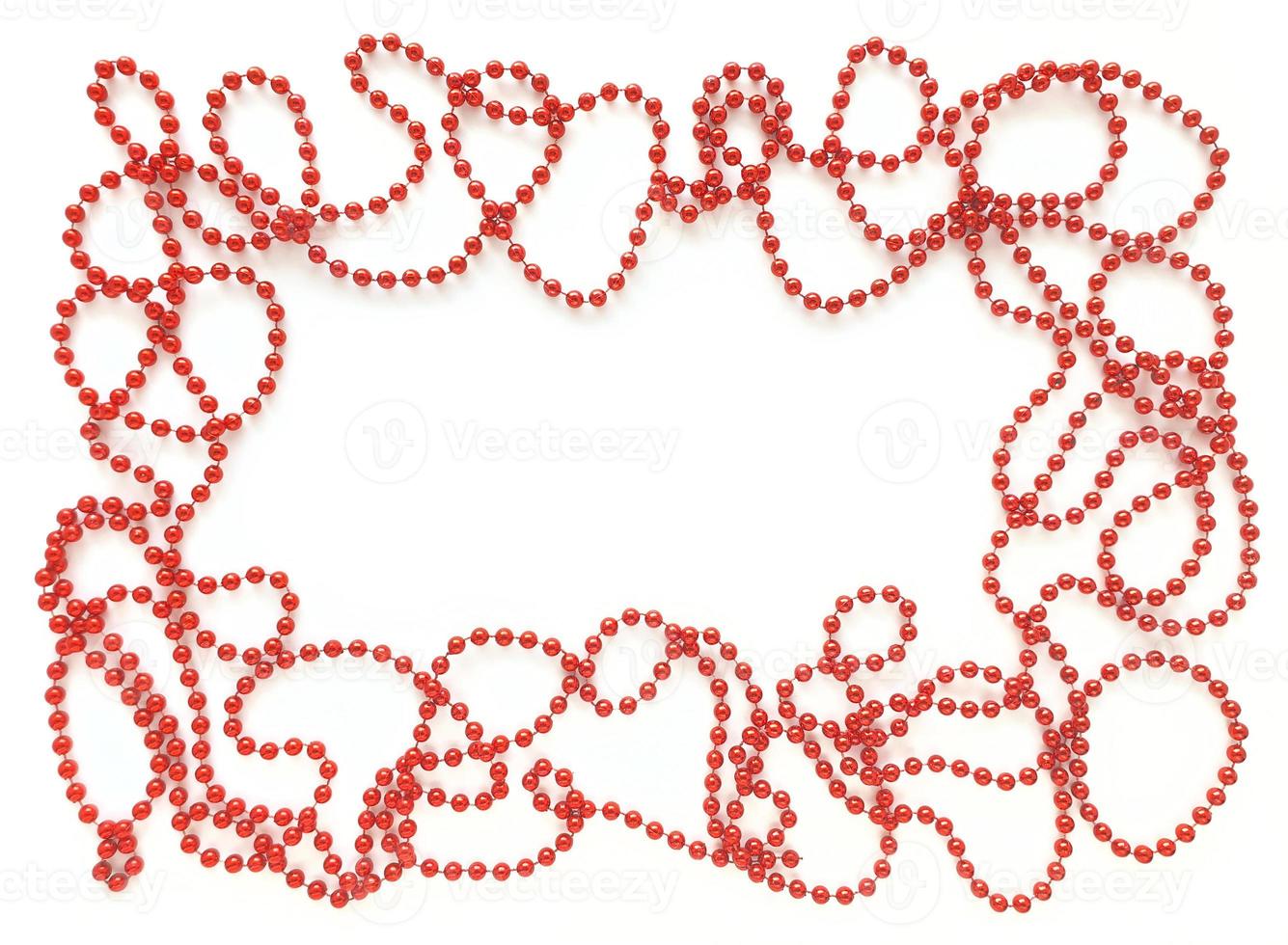 Red beads around like frame on white background. Empty space for text in the middle. Flat lay for Valentines Day or holidays. photo
