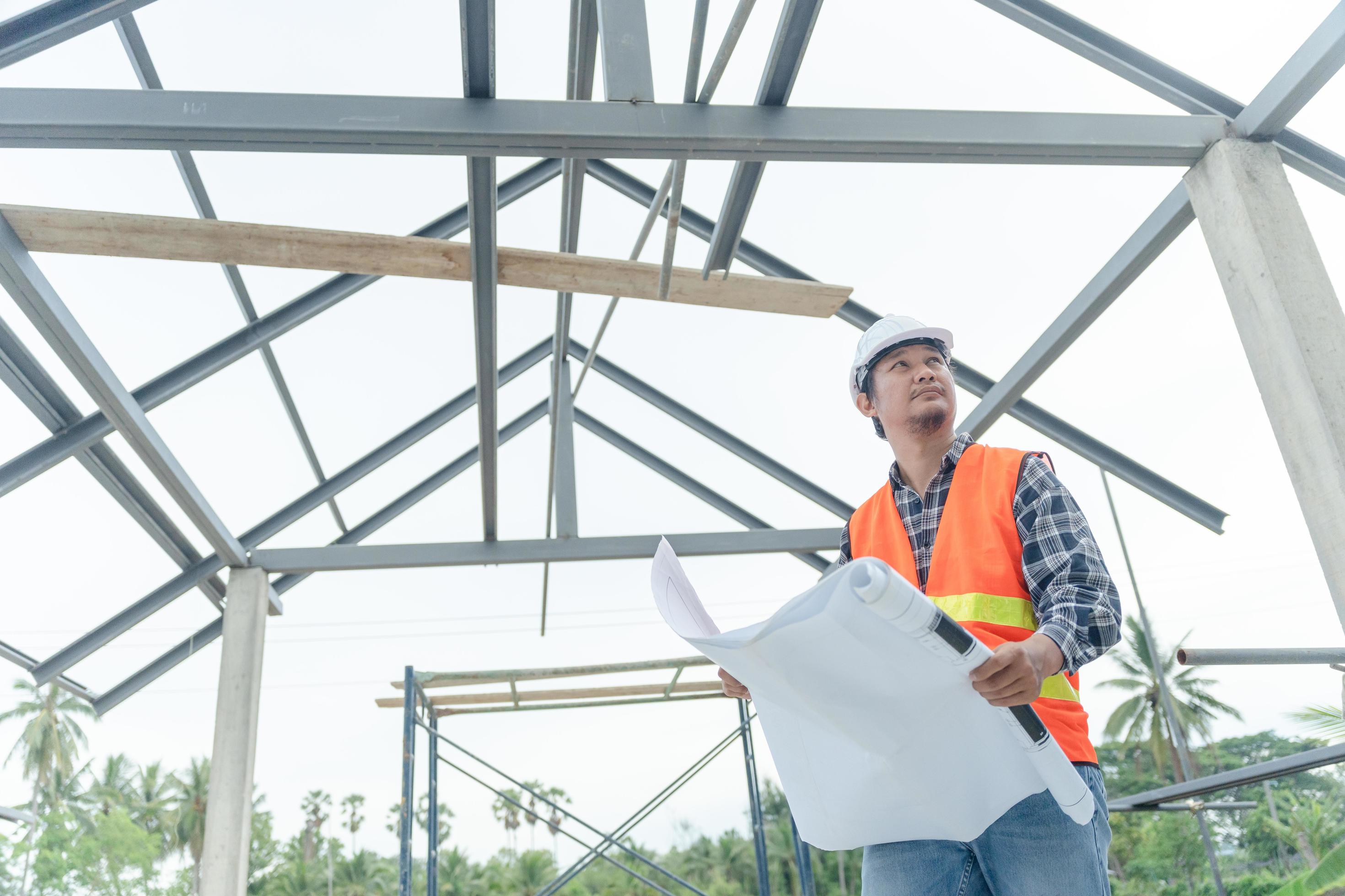 Engineers use blueprint check construction on site. Contractor and