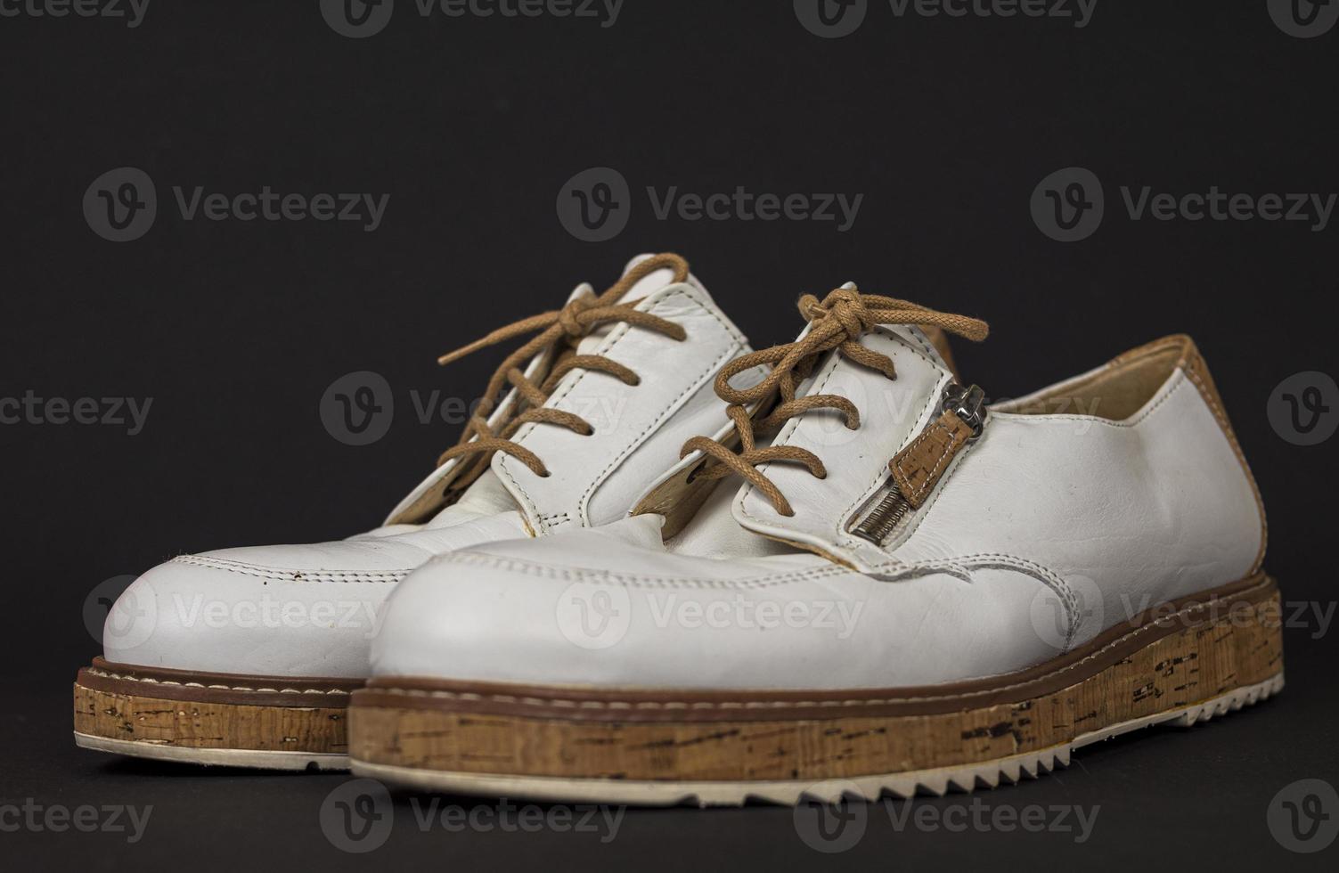 White shoes with cork soles and brown laces. many parts with different angles photo