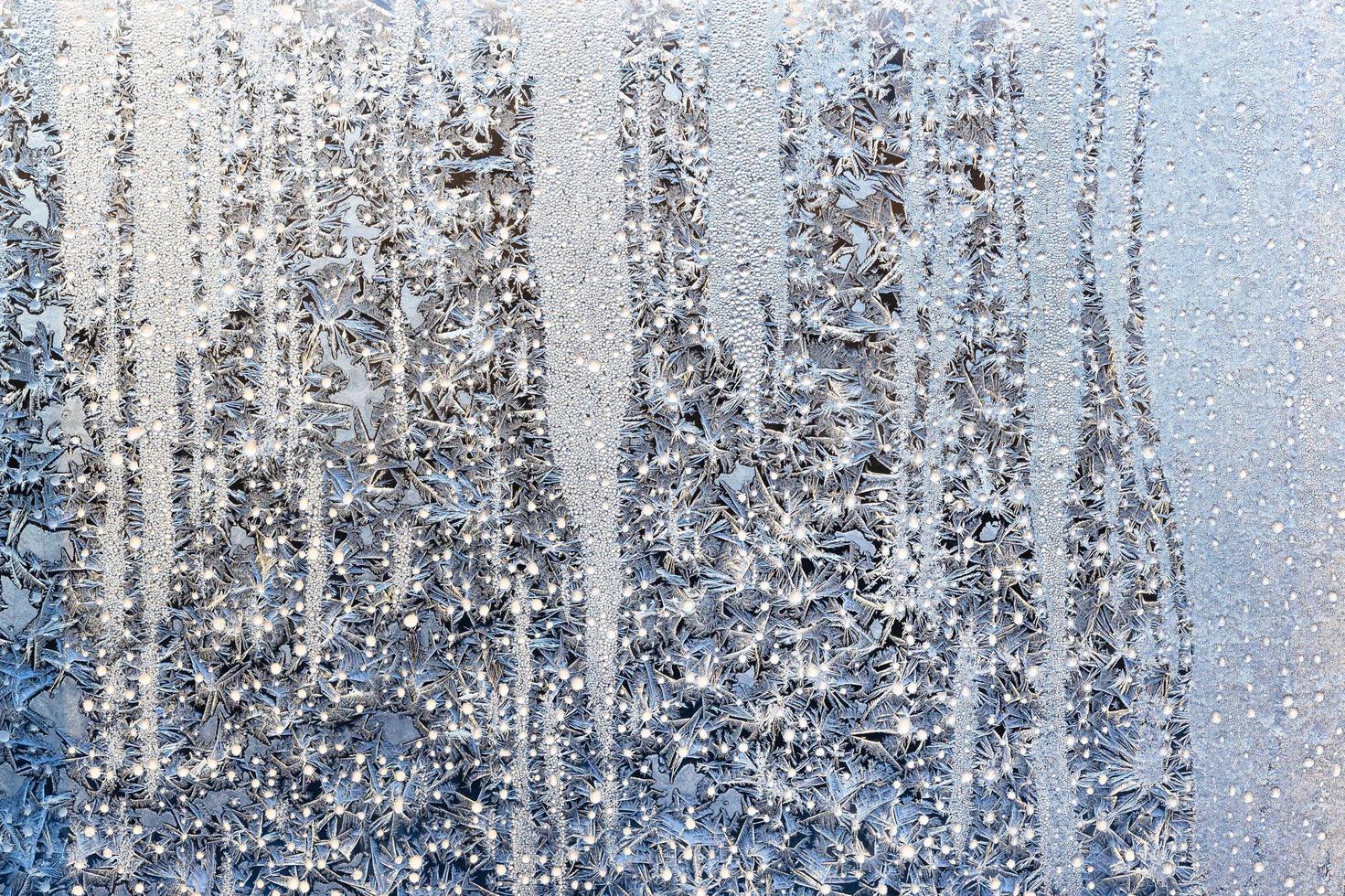 sunshine on frost on surface on home window glass photo