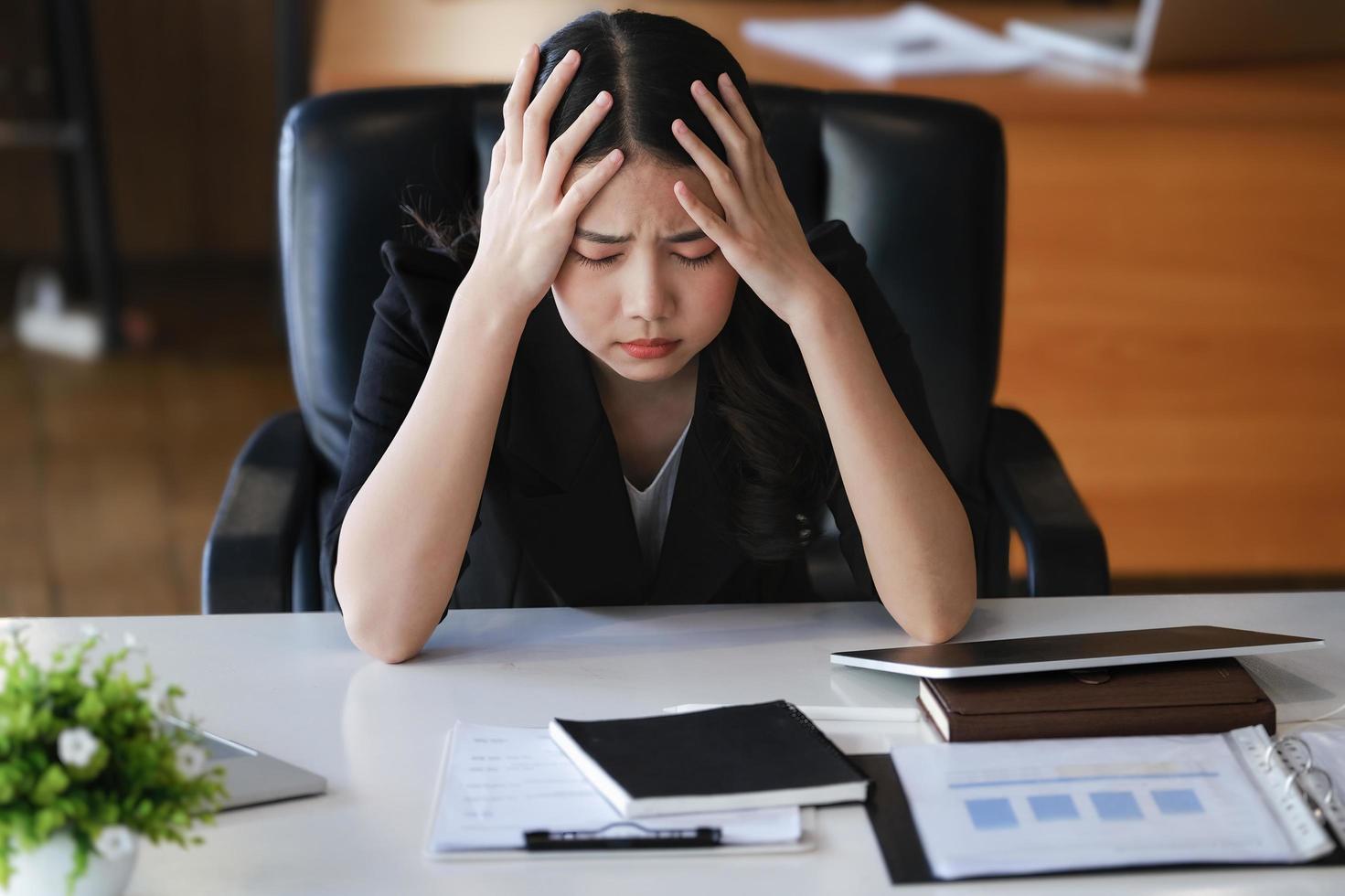 Company employees show boredom from unfinished work using computer notebook, documents and tablets at work. photo