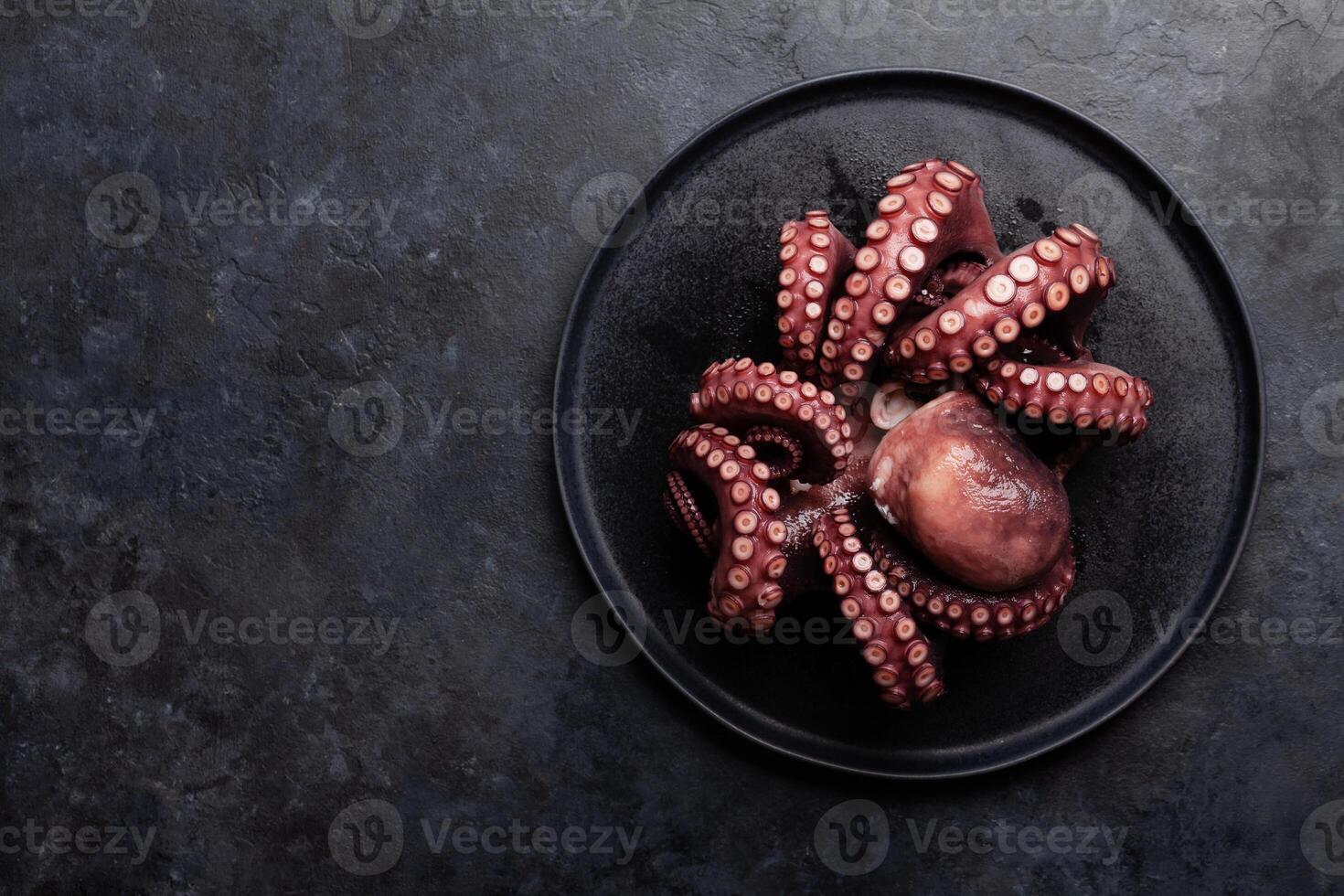 Tasty octopus on black background photo