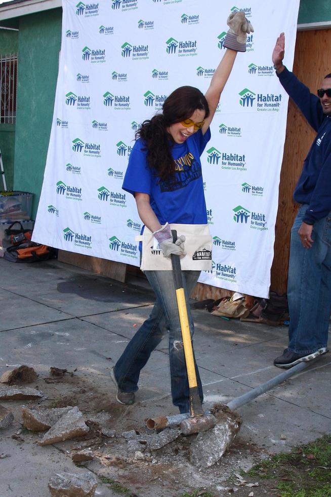 LOS ANGELES, FEB 9 - Theresa Castillo smashes concrete from a removed fence post at the 4th General Hospital Habitat for Humanity Fan Build Day at the 191 E Marker Street on February 9, 2013 in Long Beach, CA photo