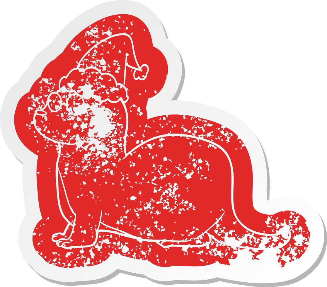 cartoon distressed sticker of a otter wearing santa hat vector