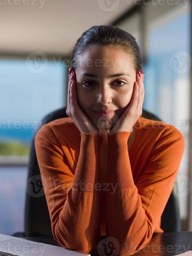 relaxed young woman at home working on laptop computer photo