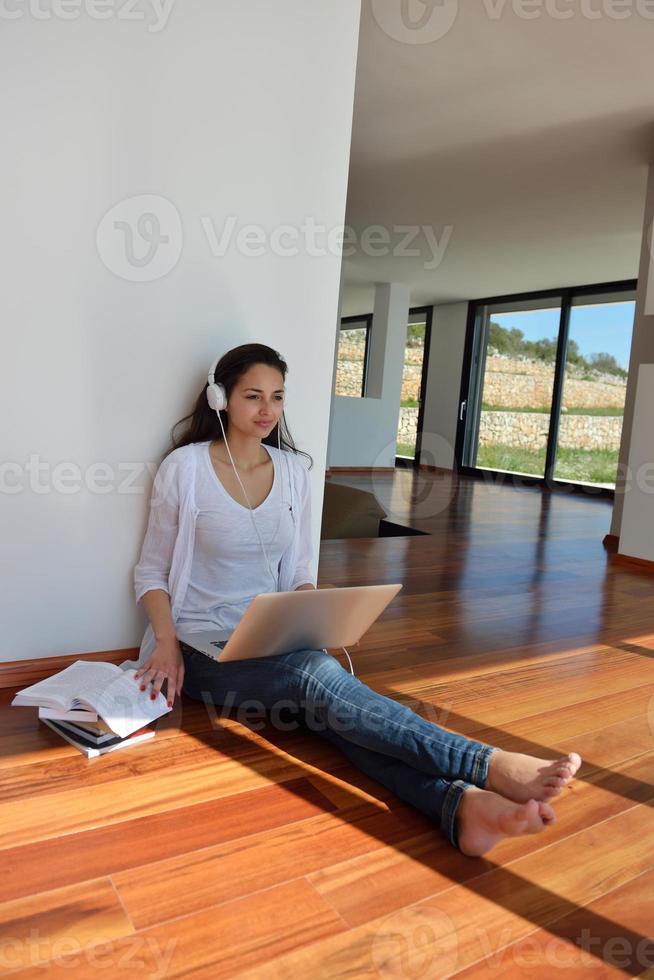 mujer joven relajada en casa trabajando en una laptop foto