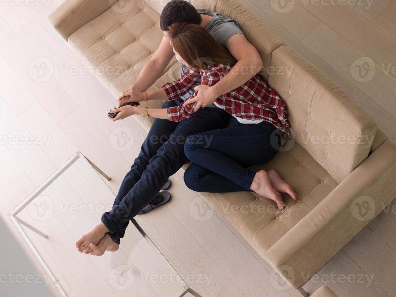 pareja joven en el sofá viendo la televisión foto