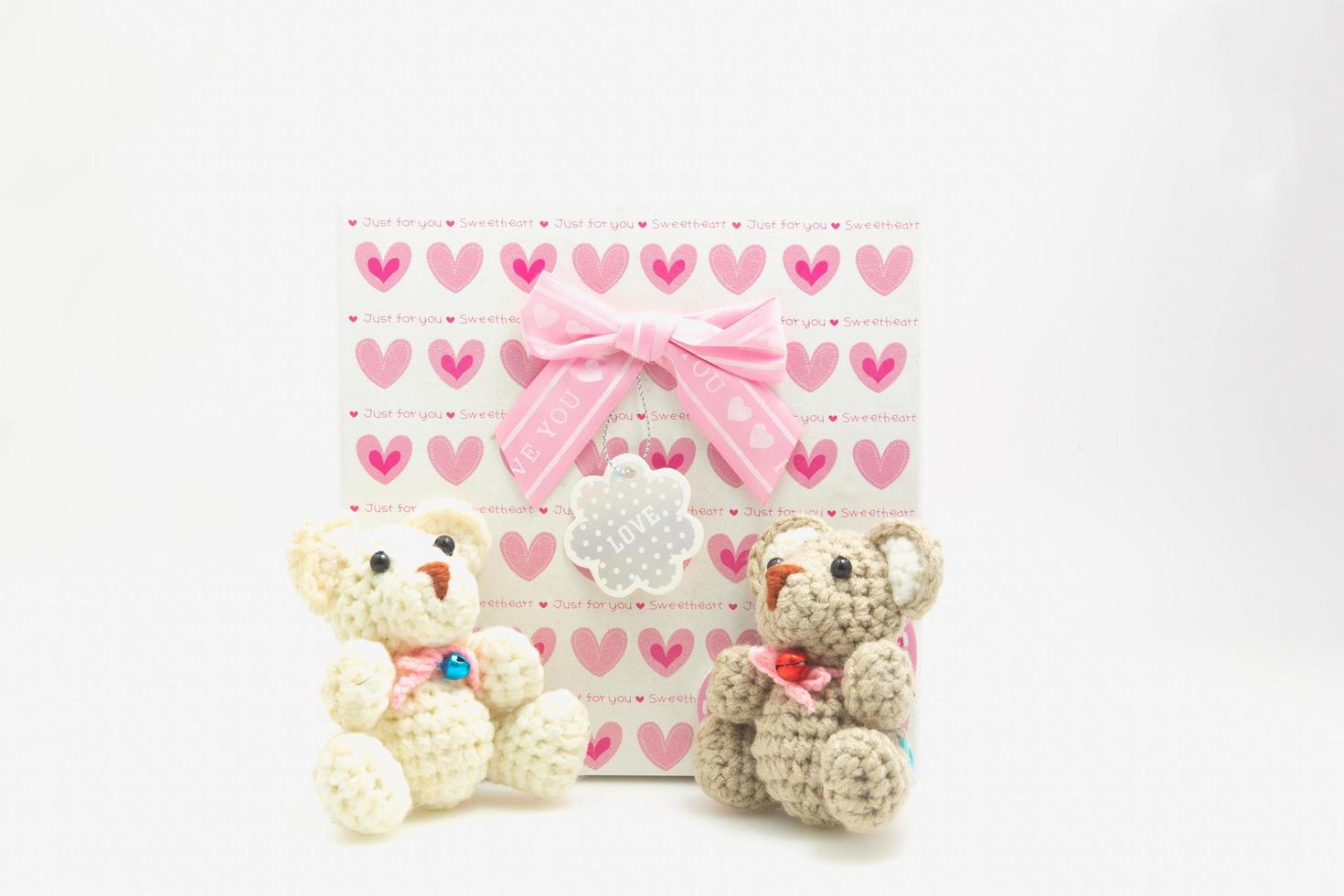 Valentines day scene Pink heart pattern gift box with a teddy bear on a white background photo