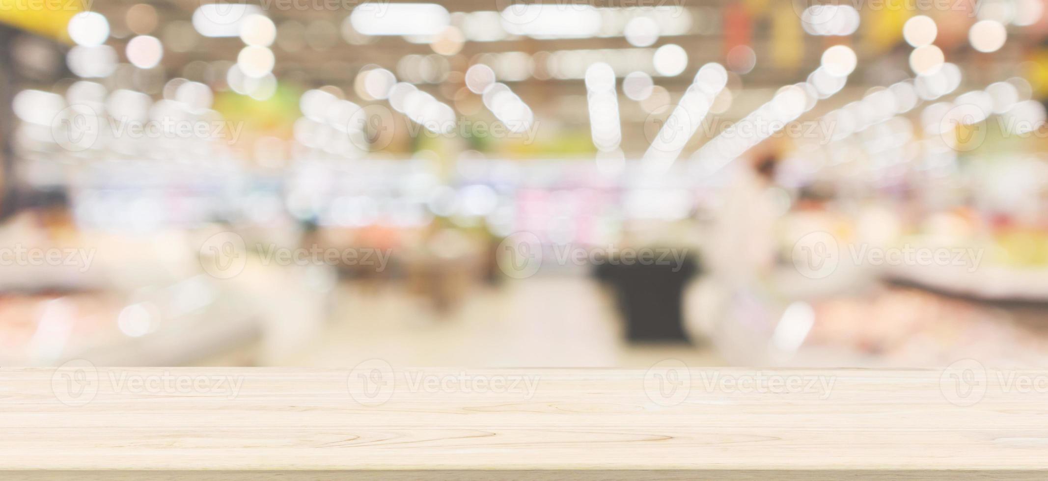 Wood table top with supermarket grocery store blurred defocused background with bokeh light photo