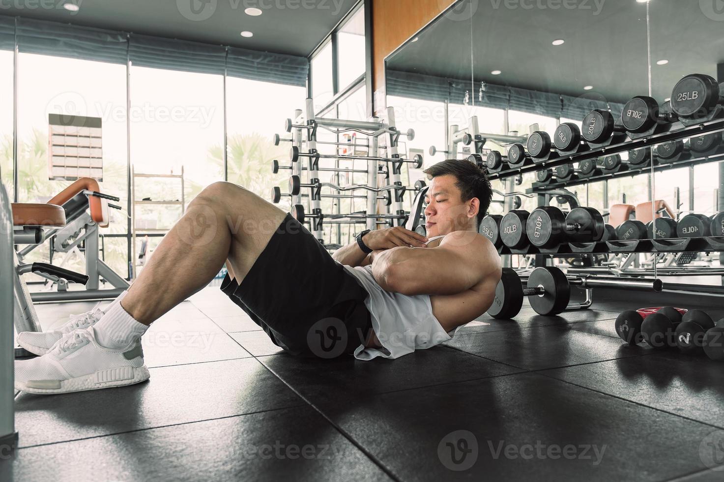Asian men do exercises by doing six-ups or push-ups. Asian bodybuilder fitness concept photo