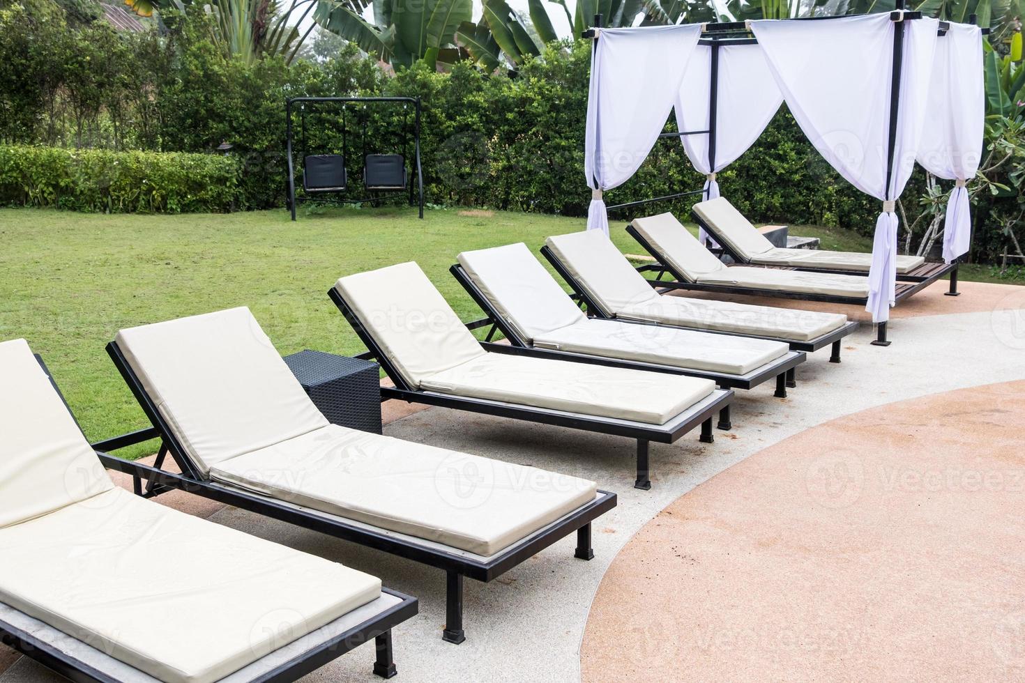 Tranquil view of the white sunbed row. photo