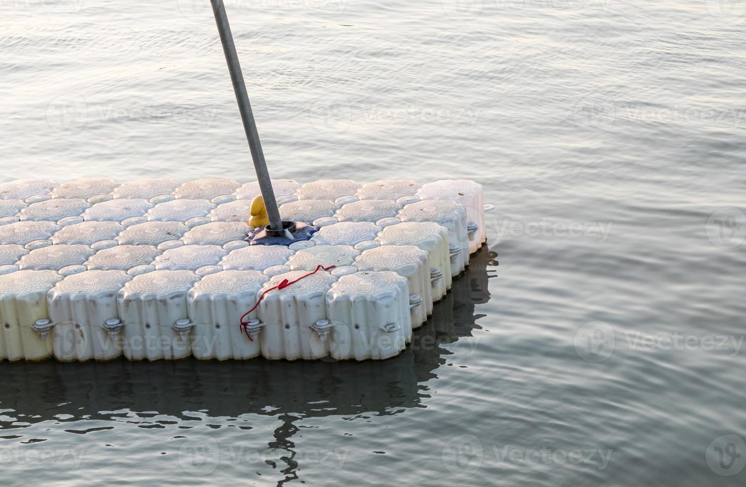 Small white plastic pontoon for the travel boat. photo