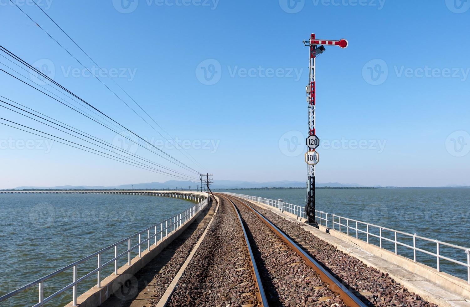 The traffic signal pole in the stop position of the railway signalling system on the curved concrete bridge. photo