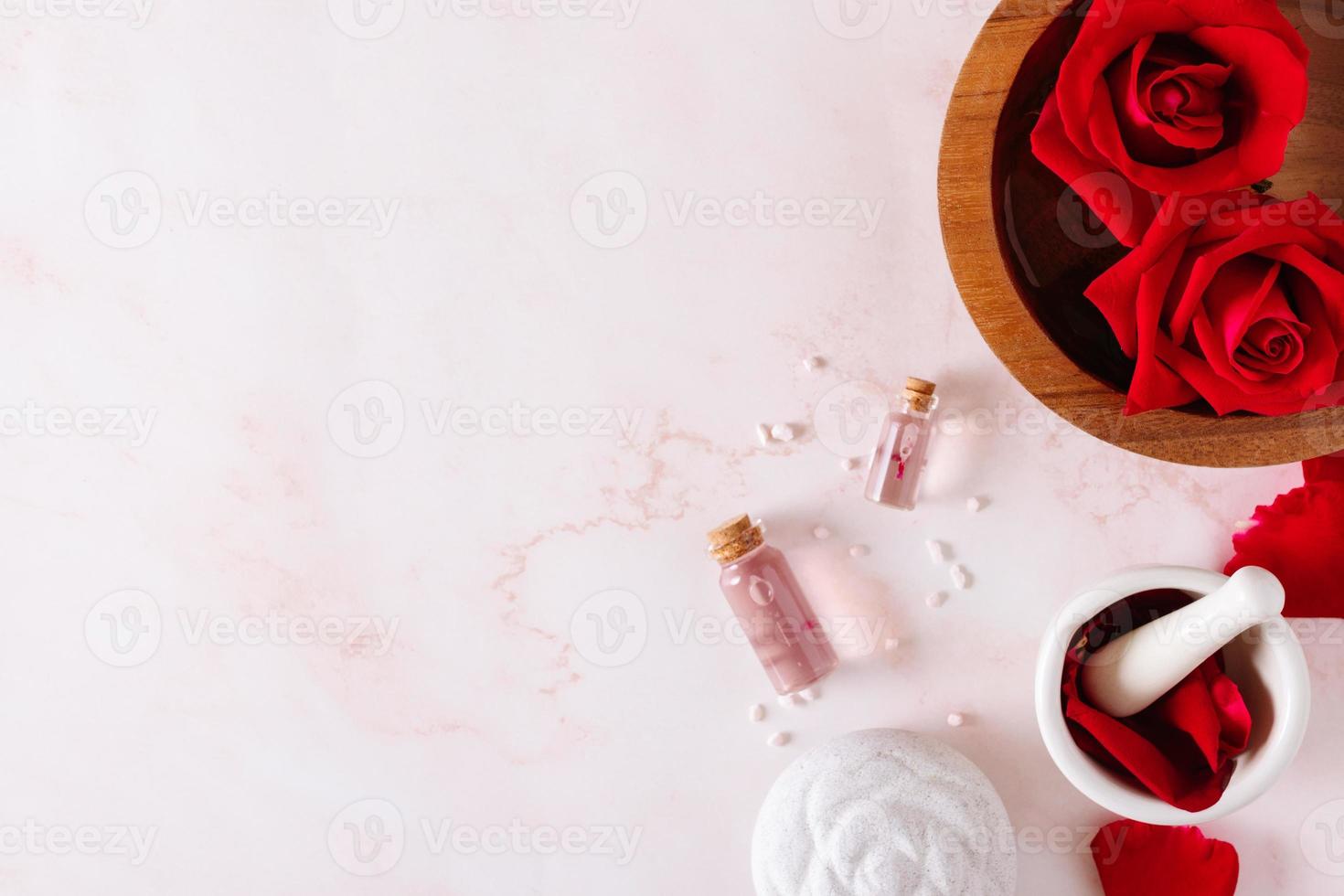 Spa bath product with rose petals on marble background. photo