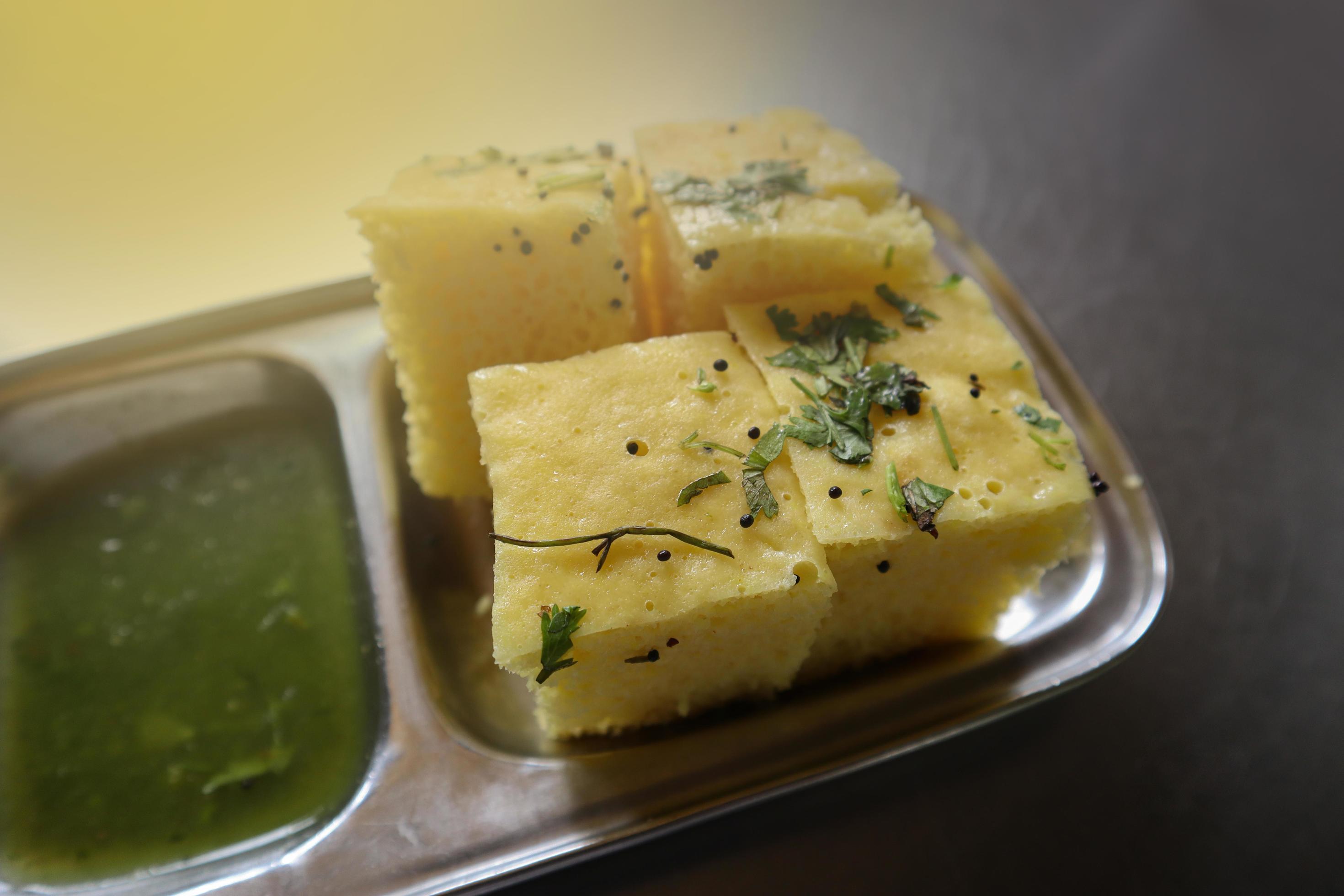 Gujarati Khaman Dhokla made using Chana Dal, served with Green chutney, selective focus 19859949