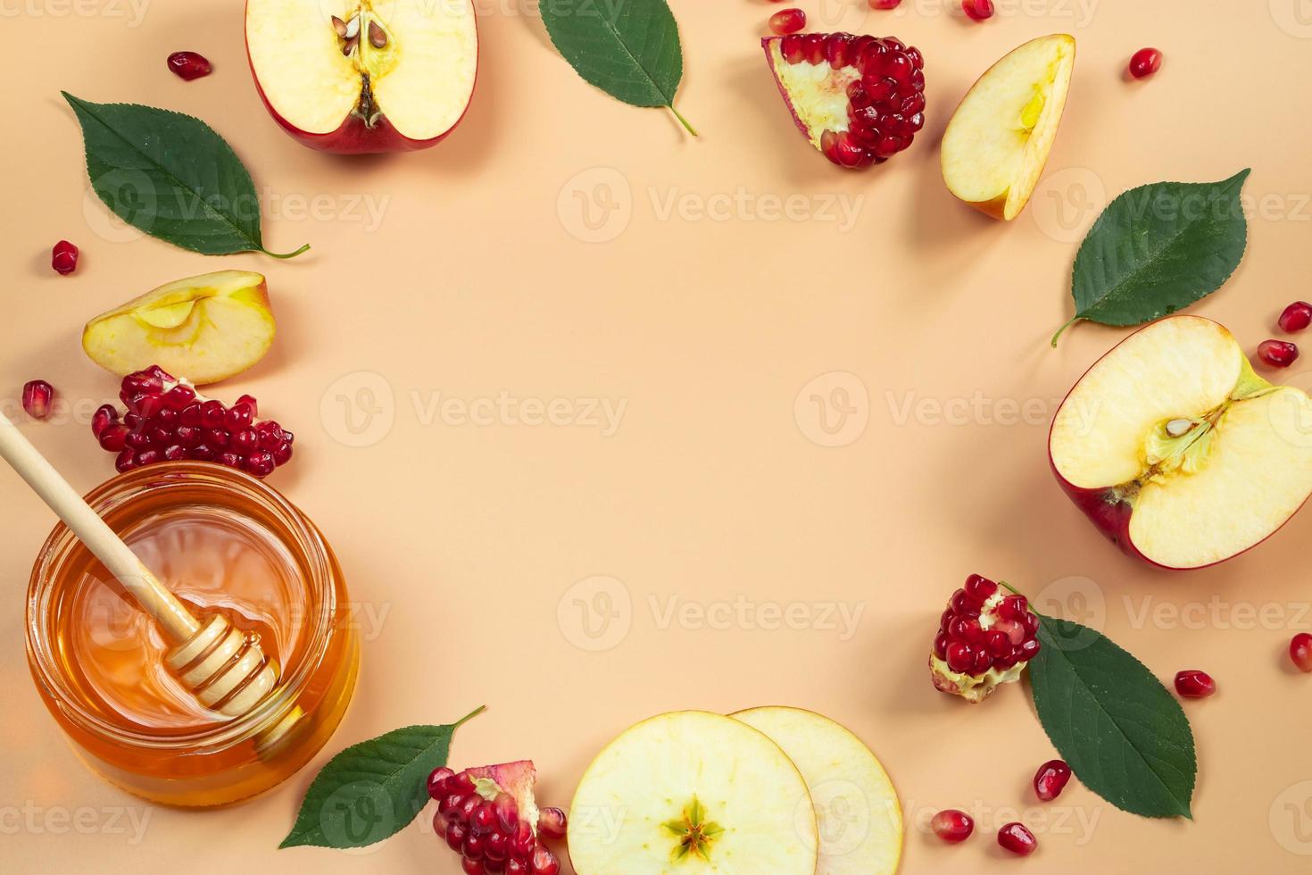 Traditional Jewish holiday New Year. Happy Rosh Hashanah. Apples, pomegranates and honey on yellow background. Place for your text. photo