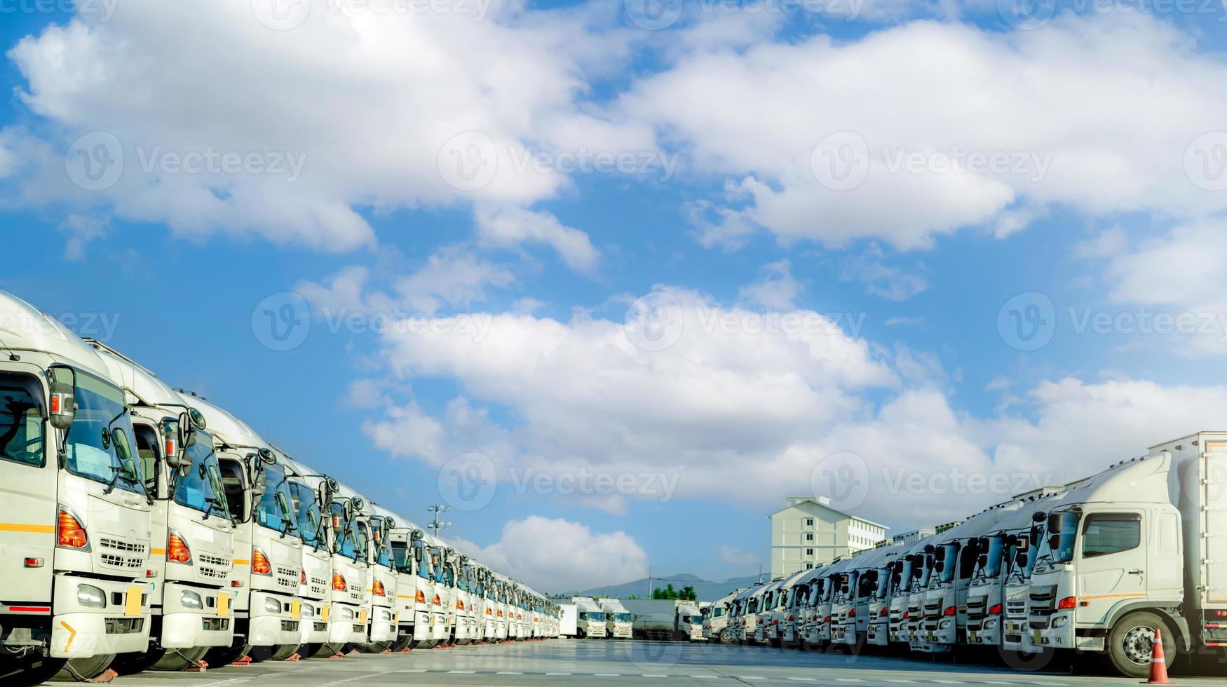 Fleet of trucks parked at parking lot yard of delivery company. Truck transport. Logistic industry. Freight transportation. Truck leasing. Commercial truck for delivering goods from warehouse. Cargo photo