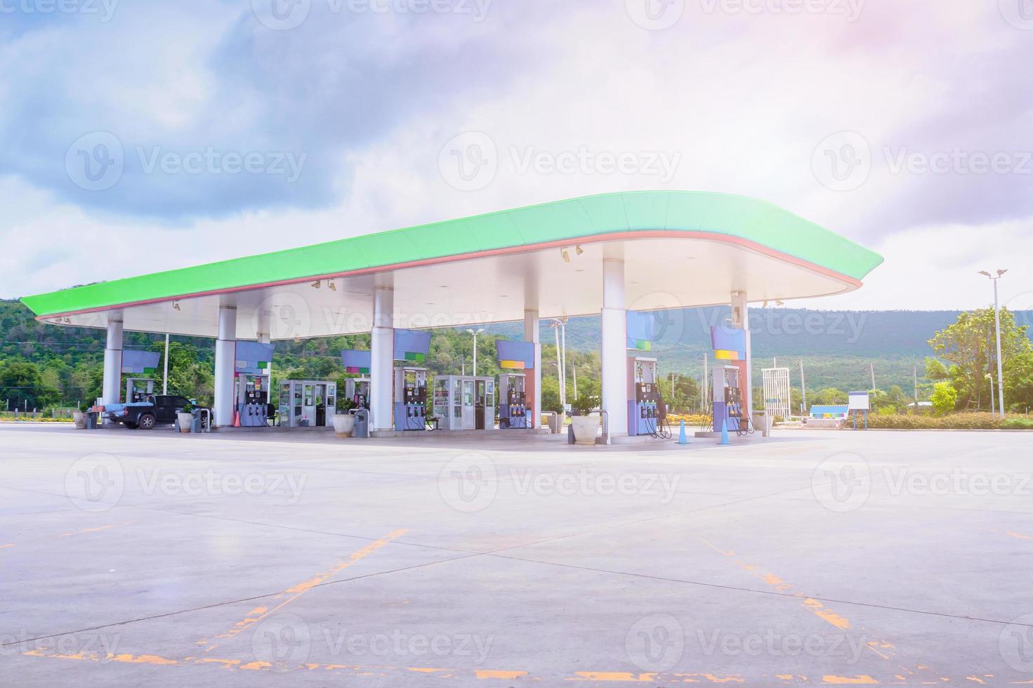 Gas fuel station with clouds in the sky and sun light photo