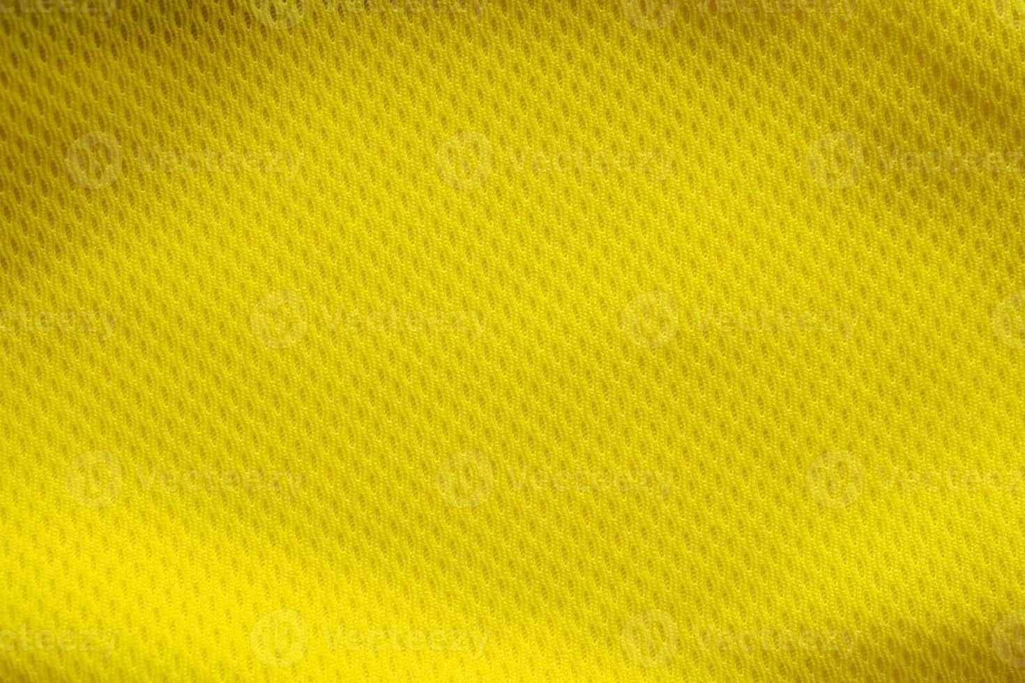 Yellow color football jersey clothing fabric texture sports wear background, close up photo