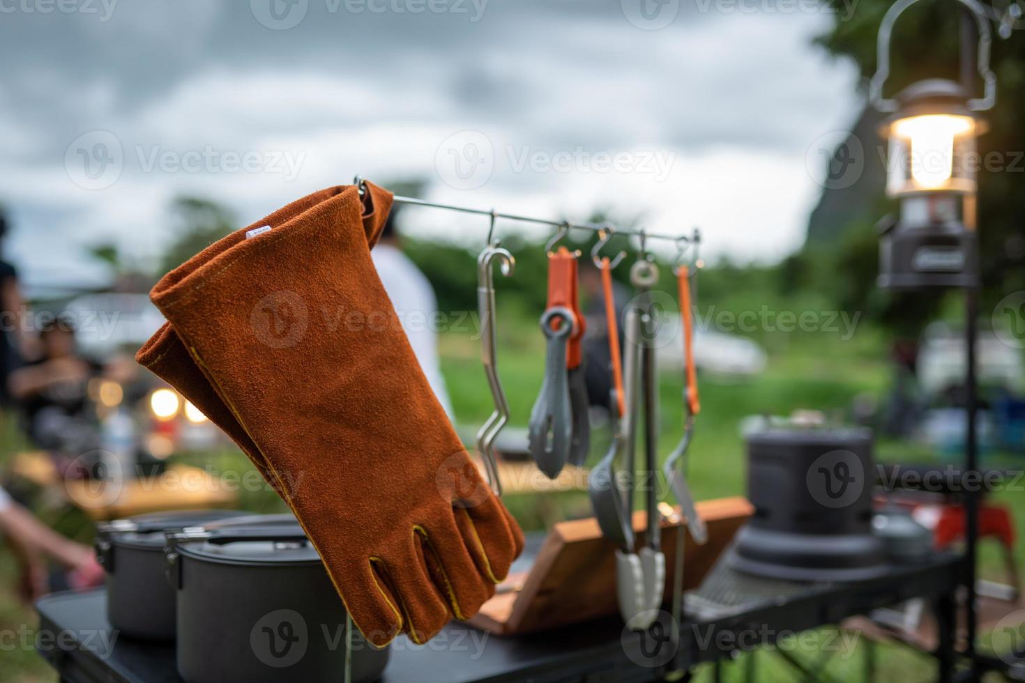 Leather gloves and kitchen utensils for camping photo