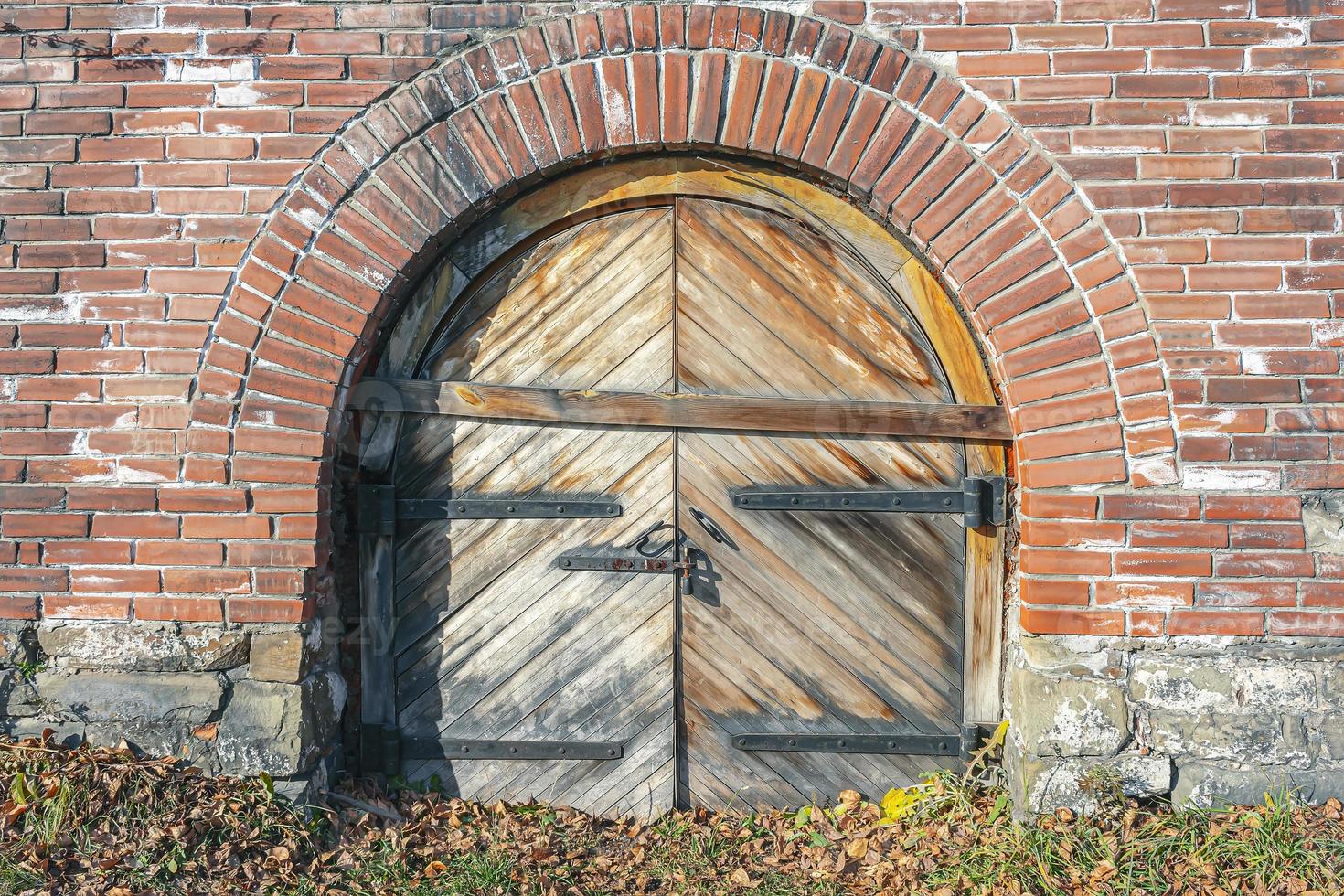 Boarded up gates of an ancient castle in autumn foliage photo