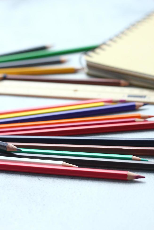 Wooden crayons scattered on the table, wooden rulers and notebooks with the festival back to the semester, students go to school, art lessons. photo