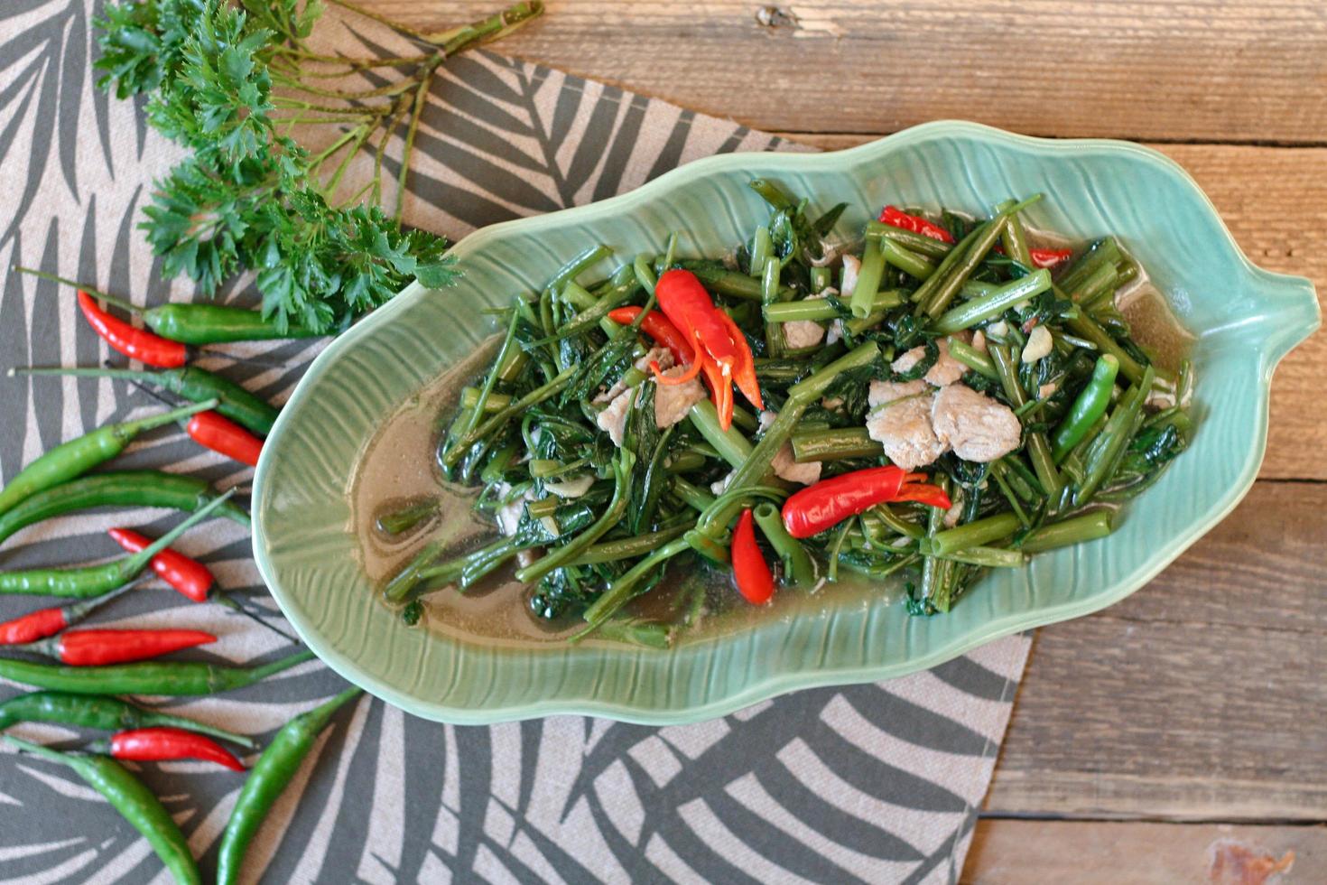 Stir-fried morning glory in a black dish Stir Fried Morning Glory is also one of the most delicious dishes you can eat in Thailand. photo