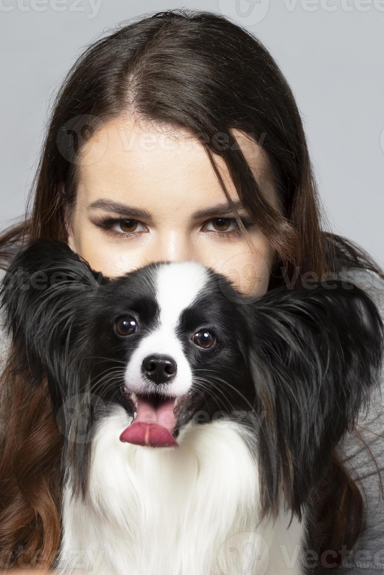 A cute young woman is hugging her papillon puppy. The eyes of a beautiful girl and the eyes of a funny dog with big ears. 19874759 Stock Photo at Vecteezy A cute young woman is hugging her papillon puppy. The eyes of a beautiful girl and the eyes of a funny dog with big ears. 19874759 Stock Photo at Vecteezy