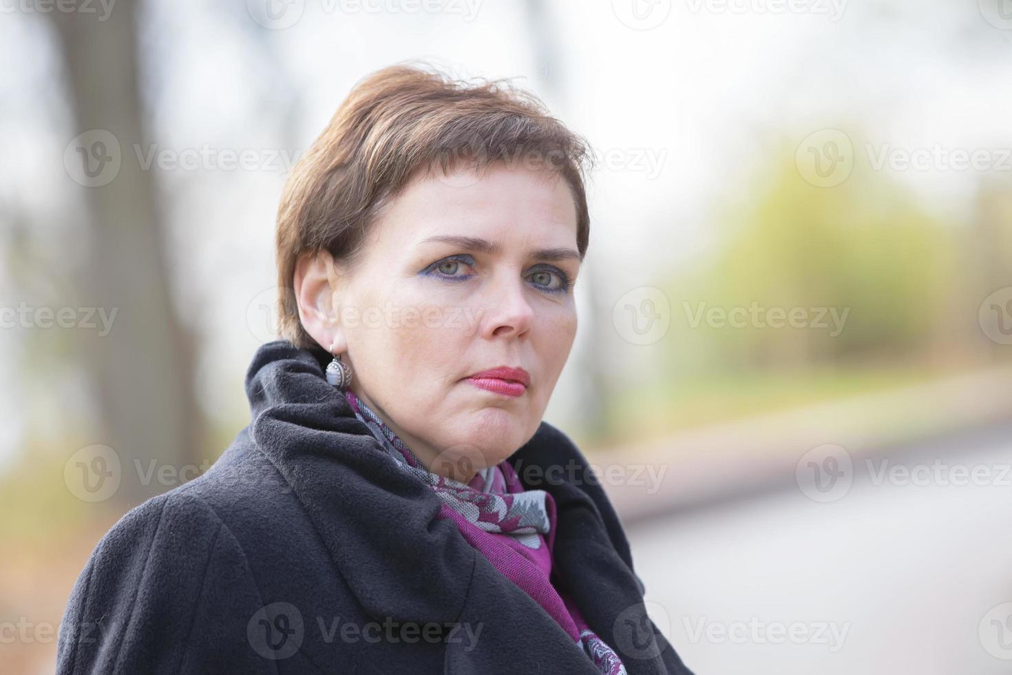 Portrait of a fifty-year-old woman with a short haircut. The face of a middle-aged woman. photo