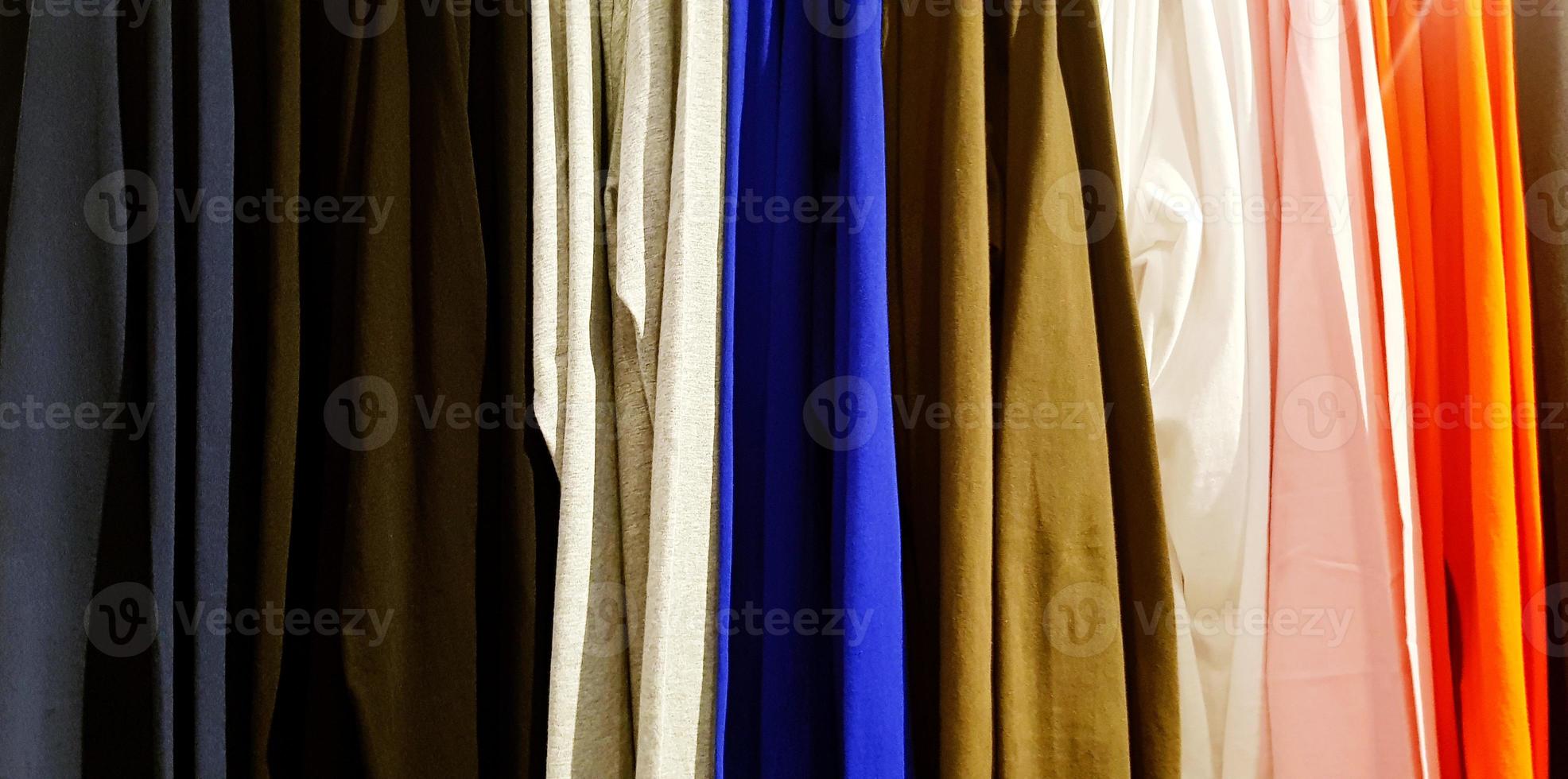 Colorful pattern of clothing, cotton, curtain or fabric hanging in line at fashion store for background photo