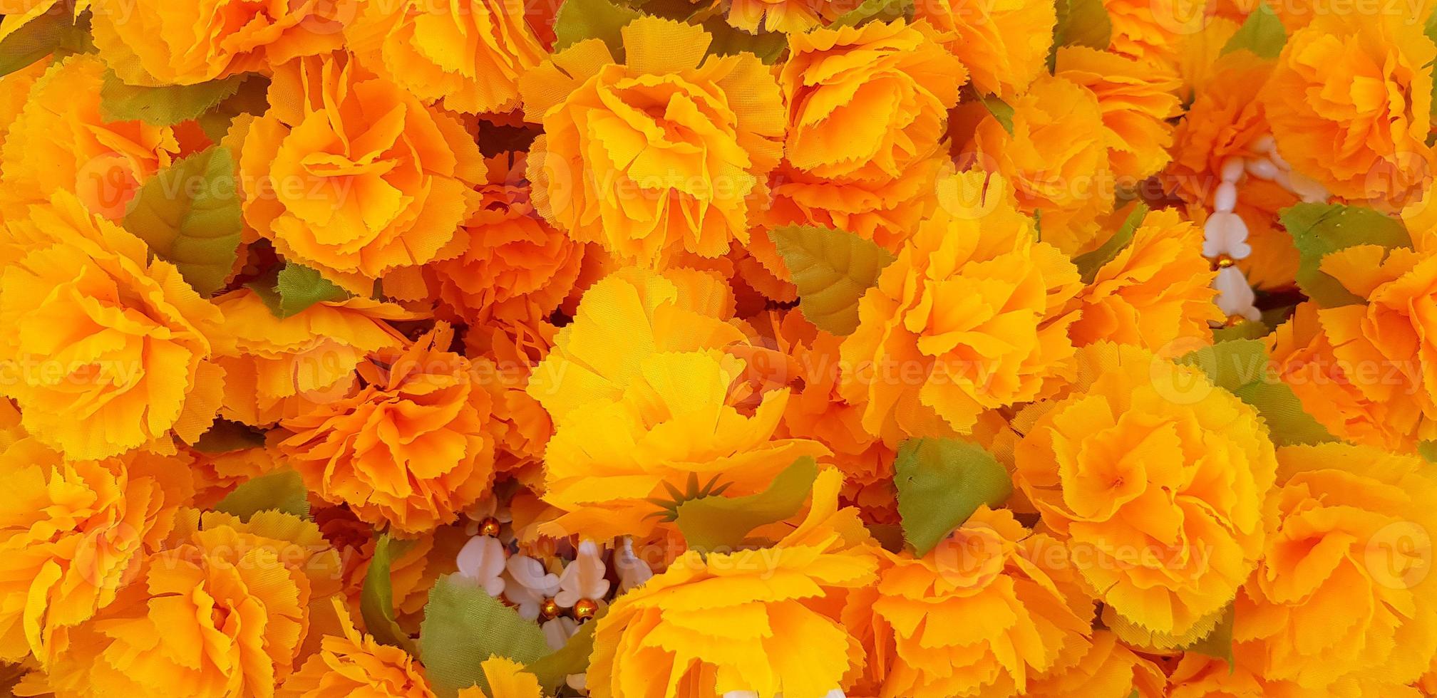 Many garland and yellow flower for worship the Buddha at Thai temple for background. Religion, Culture and Respect or Faith concept photo