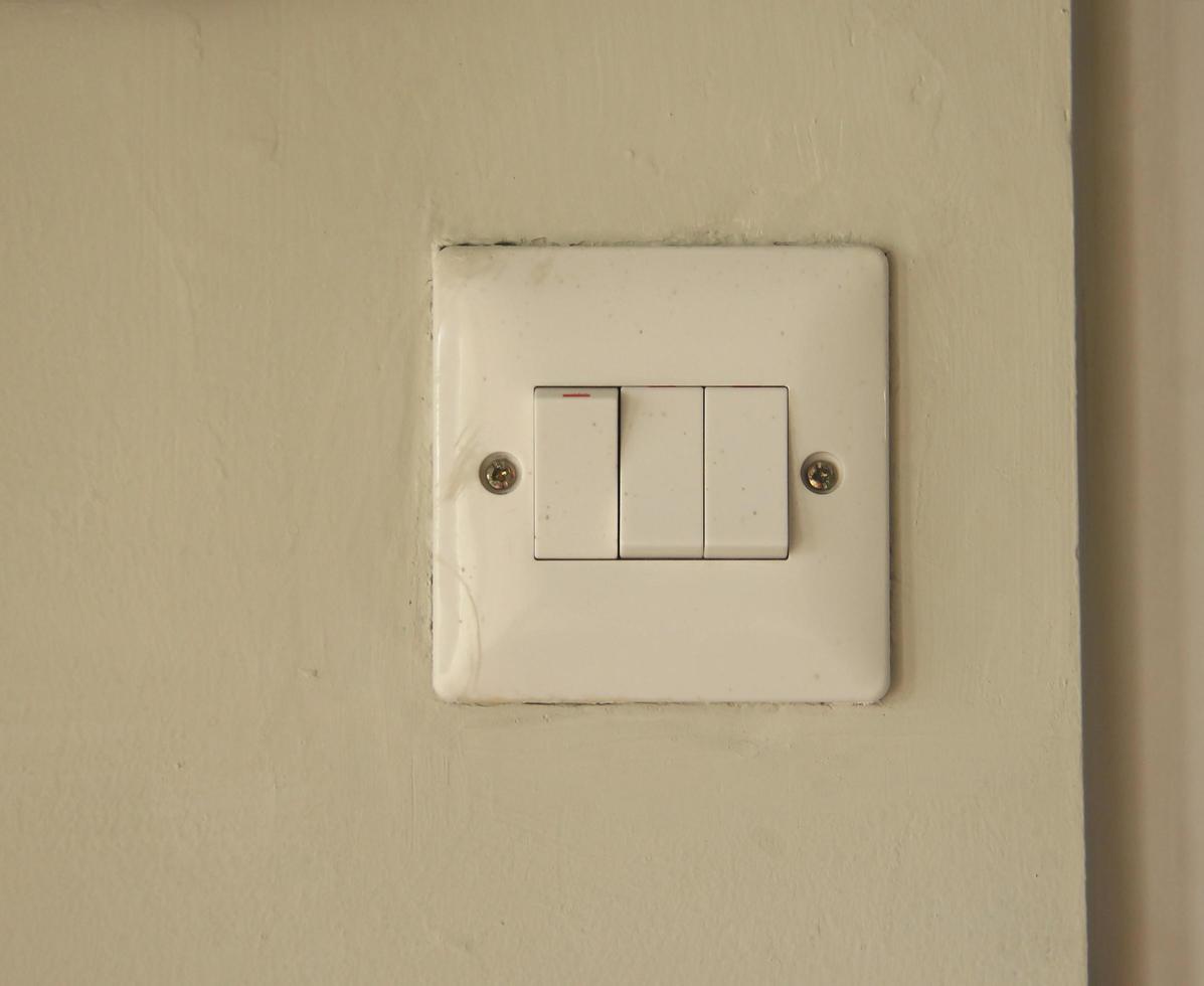 Dirty old white light switch electricity photo isolated on wall background