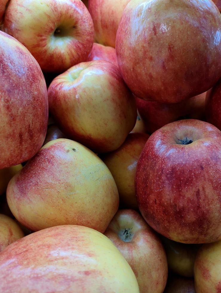 Close up pile of red apples in supermarket. Healthy vegetarian fruit photo isolated on landscape template. A bunch of sweet fruits.