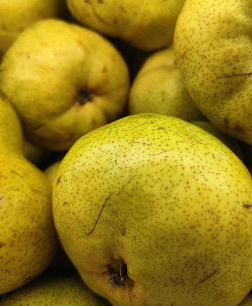 Close up pile of yellow pears in supermarket. Healthy vegetarian fruit photo isolated on landscape template. A bunch of sweet fruits.