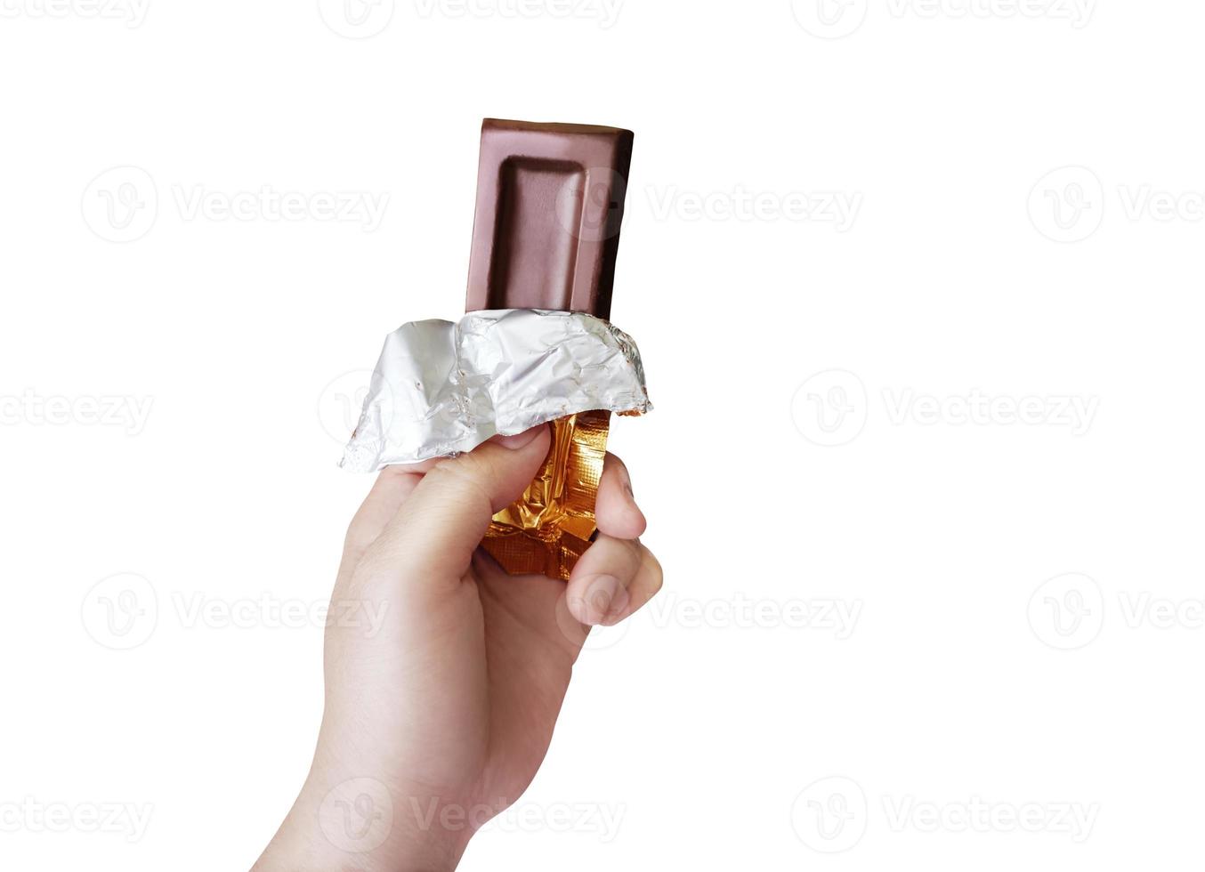 Chocolate bar candy in hand isolated on white background photo