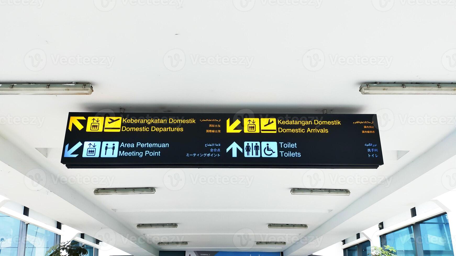 Sign direction at the Indonesian Airport, Translate in english Domestic departures, Domestic Arrivals, Meeting point, and Toilets. photo