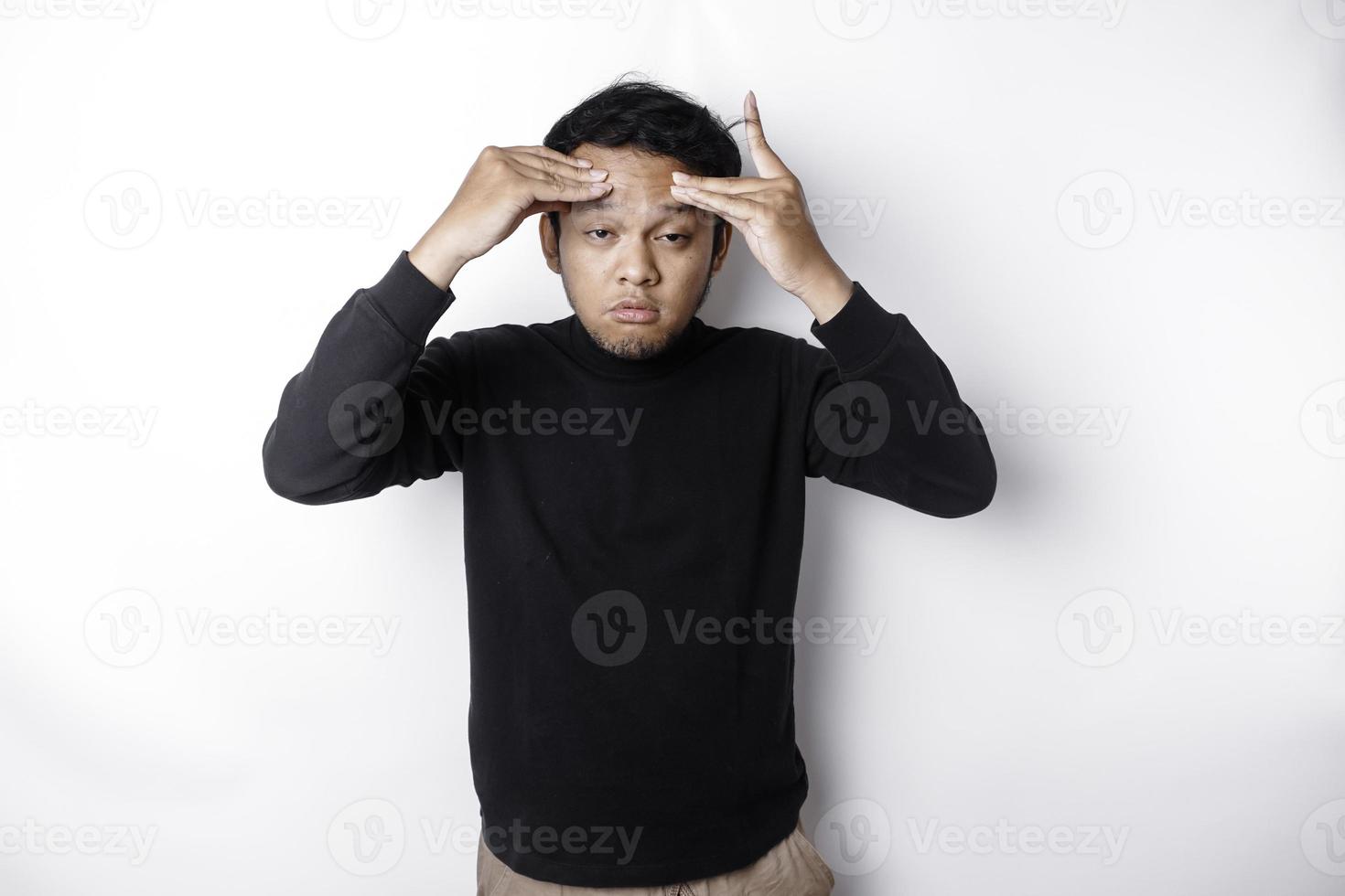 A portrait of an Asian man wearing a black shirt isolated by white background looks depressed photo