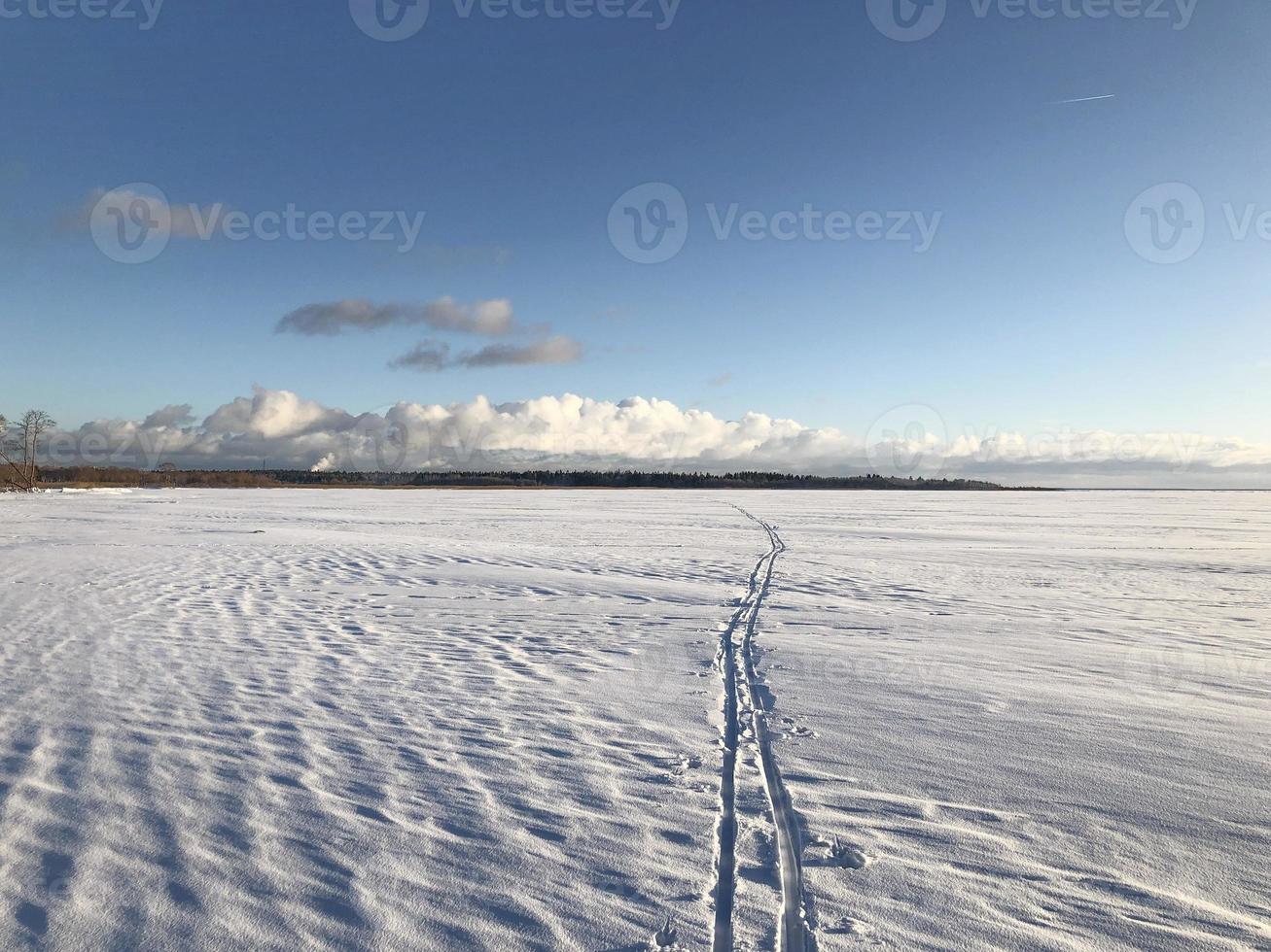 ski track going to the horizon, snowy winter landscape photo