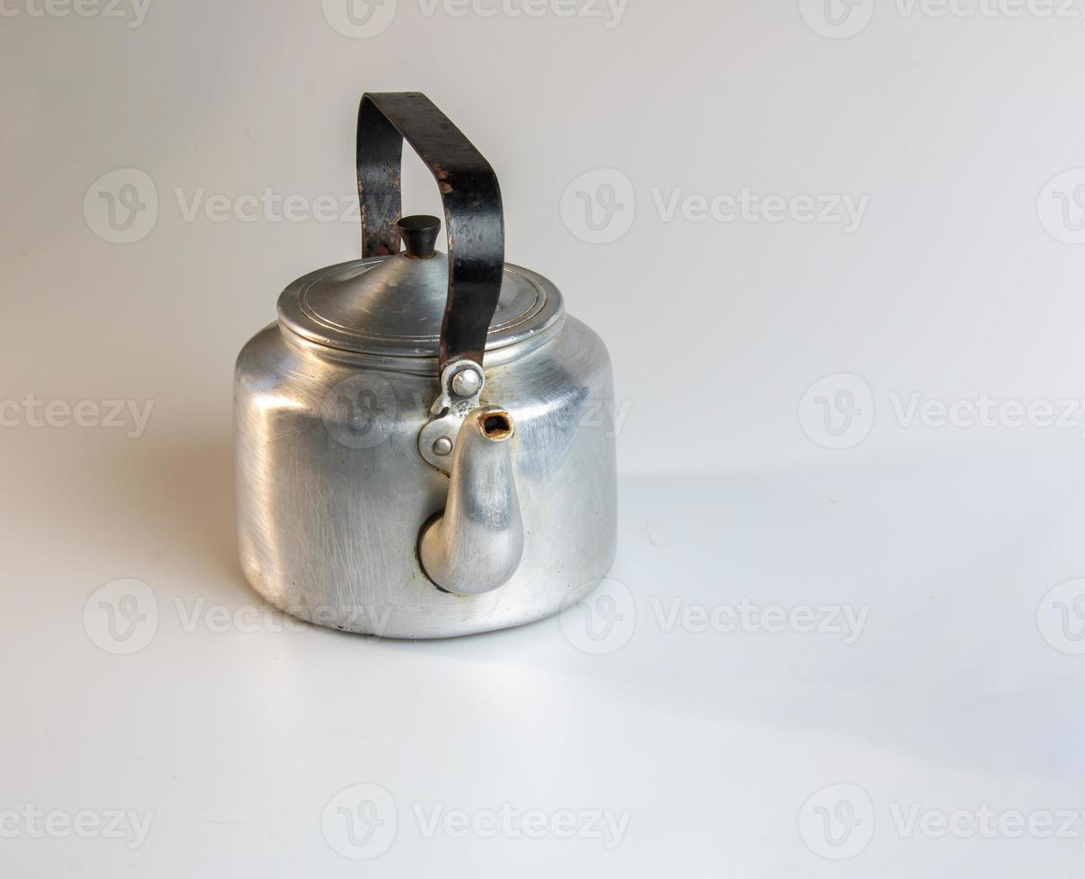 Old soldier's aluminum teapot from the Second World War on a white background. photo