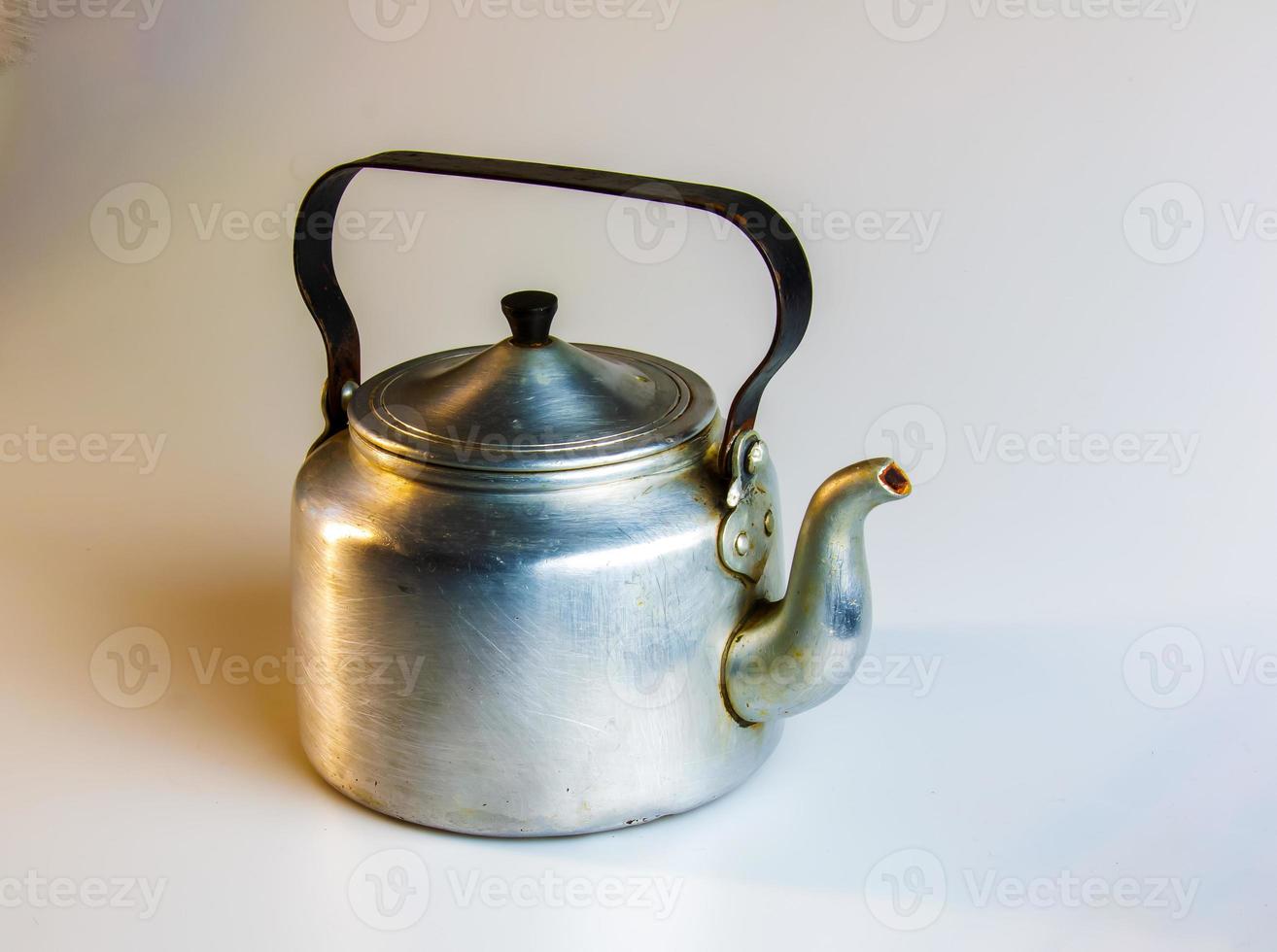 Old soldier's aluminum teapot from the Second World War on a white background. photo