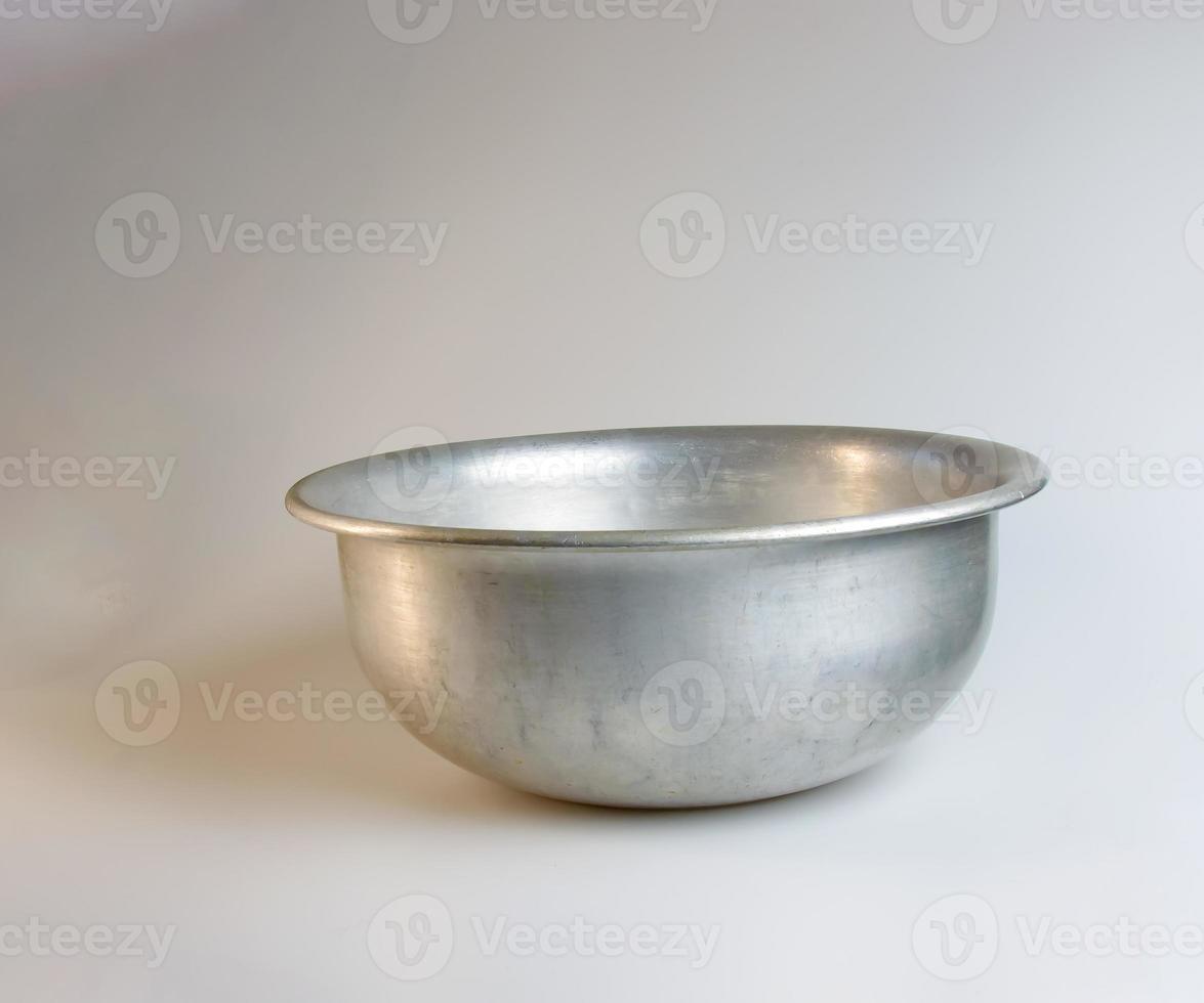 An old aluminum bowl made in circa 1960 against a white background. photo