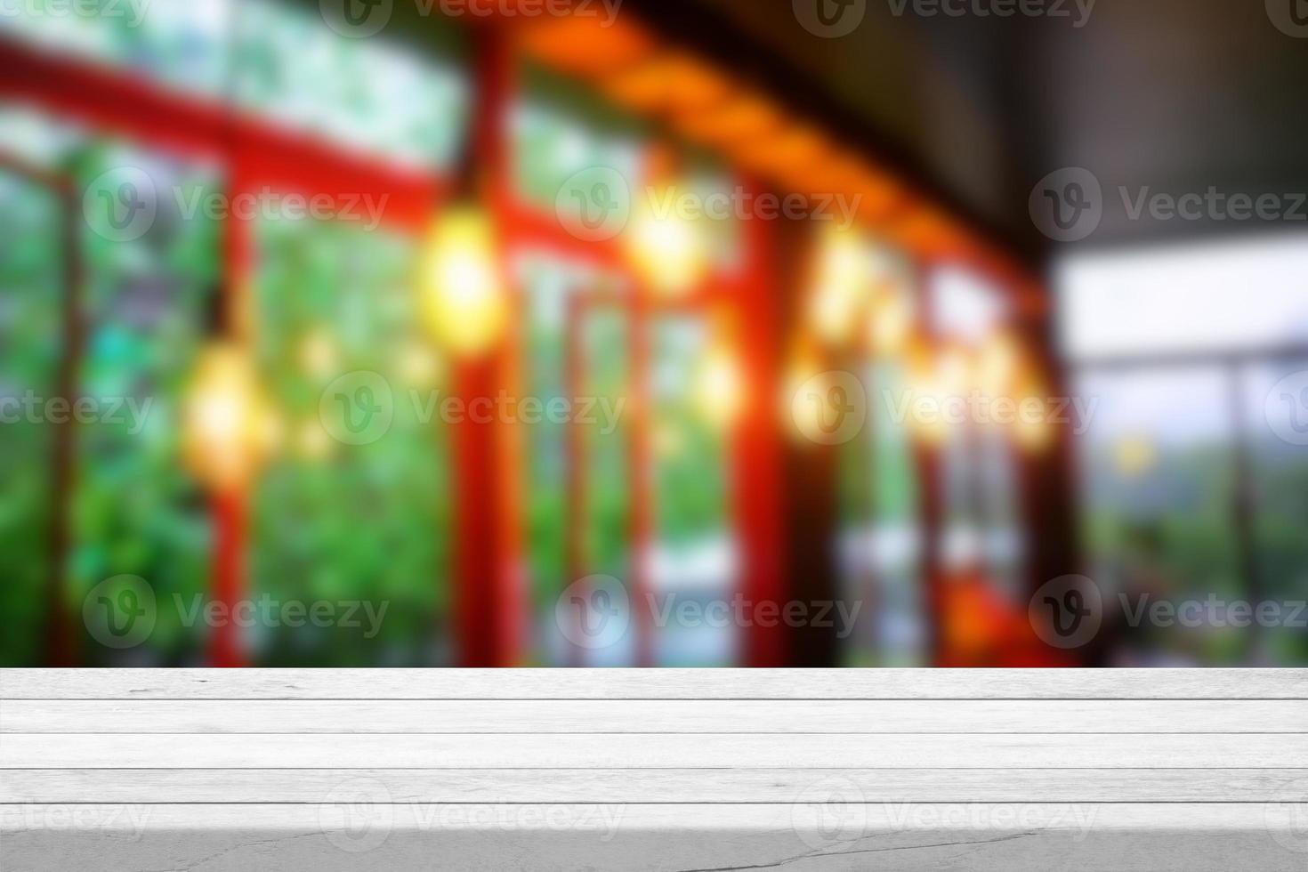 White Wood Table with Blurred Hanging Bulbs in Cafe Interior Background, Suitable for Product Presentation Backdrop, Display, and Mock up. photo